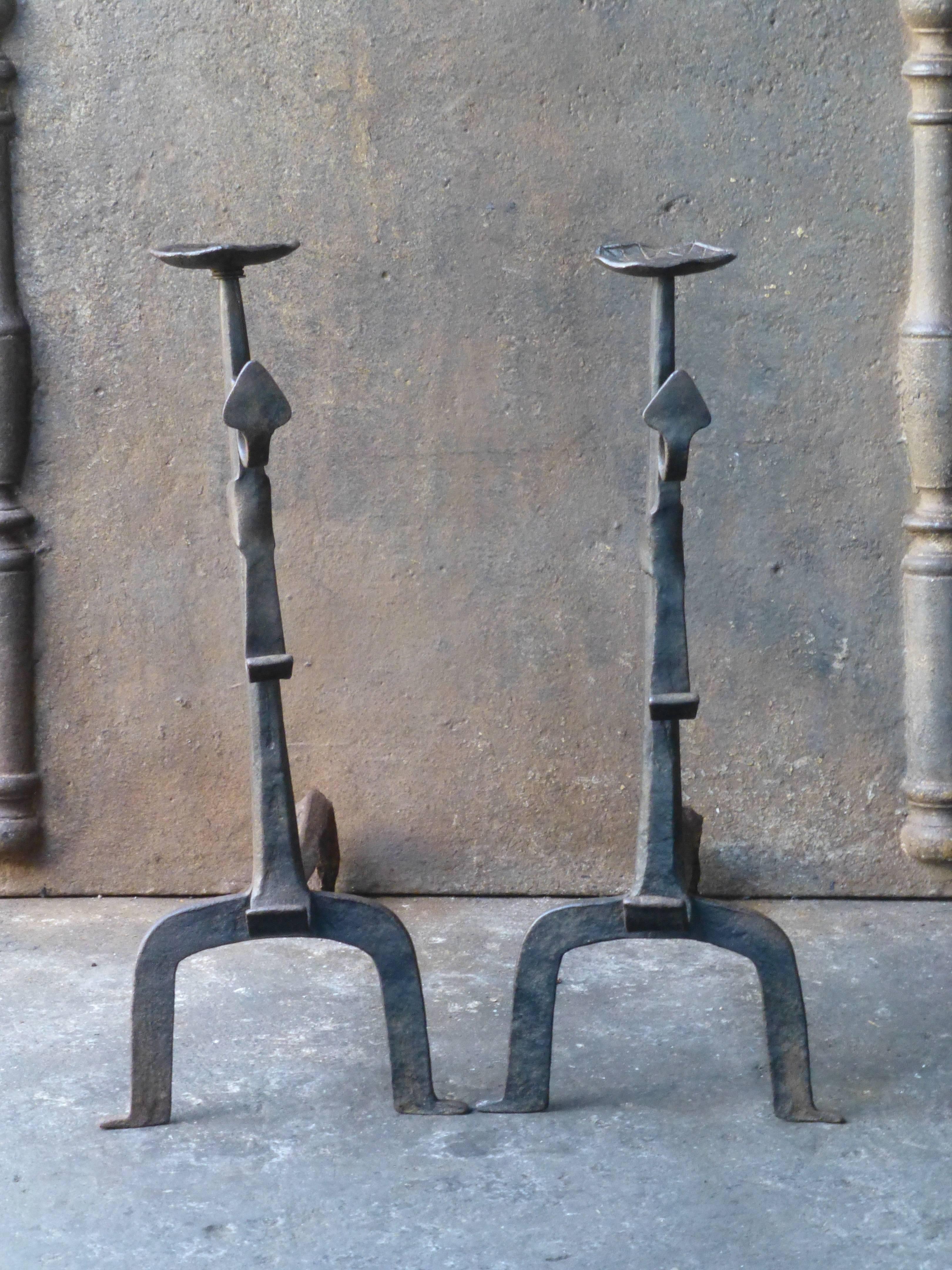 18th century French andirons, fire dogs made of wrought iron. These French andirons are called 'landiers' in France. This dates from the times the andirons were the main cooking equipment in the house. They had spit hooks to grill meat or poultry