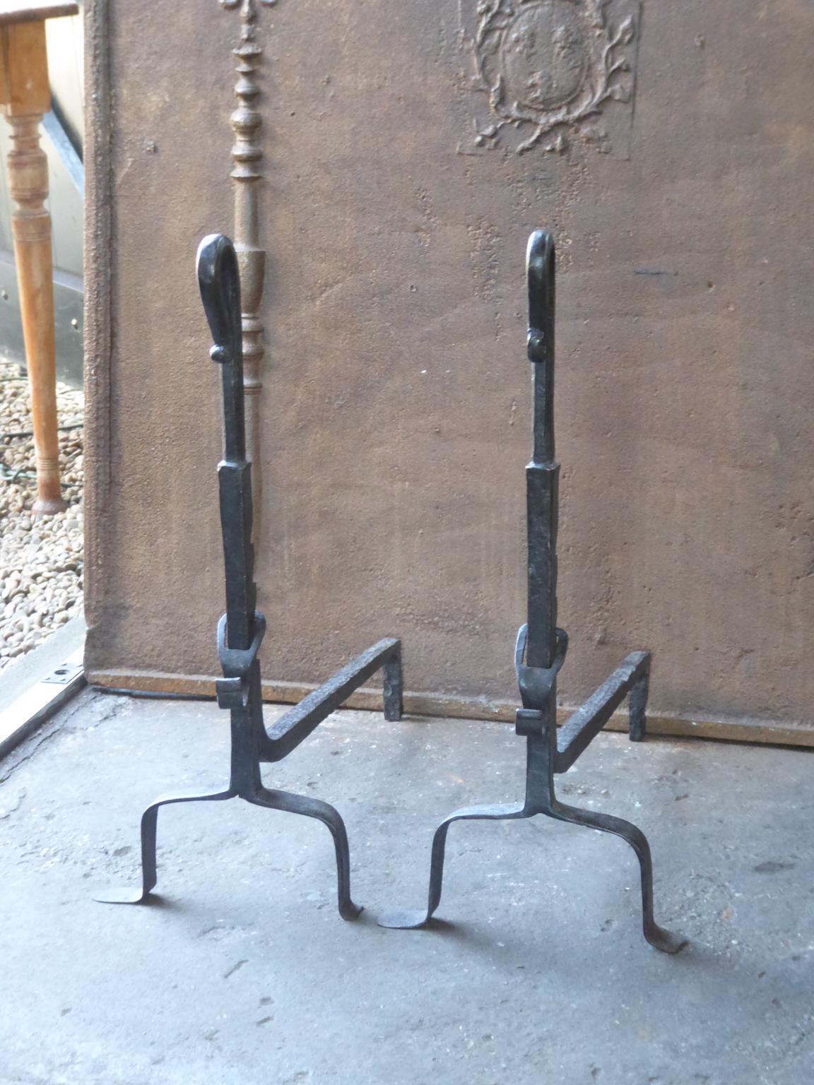 18th century French andirons, fire dogs made of wrought iron. These French andirons are called 'landiers' in France. This dates from the times the andirons were the main cooking equipment in the house. They had spit hooks to grill meat or poultry