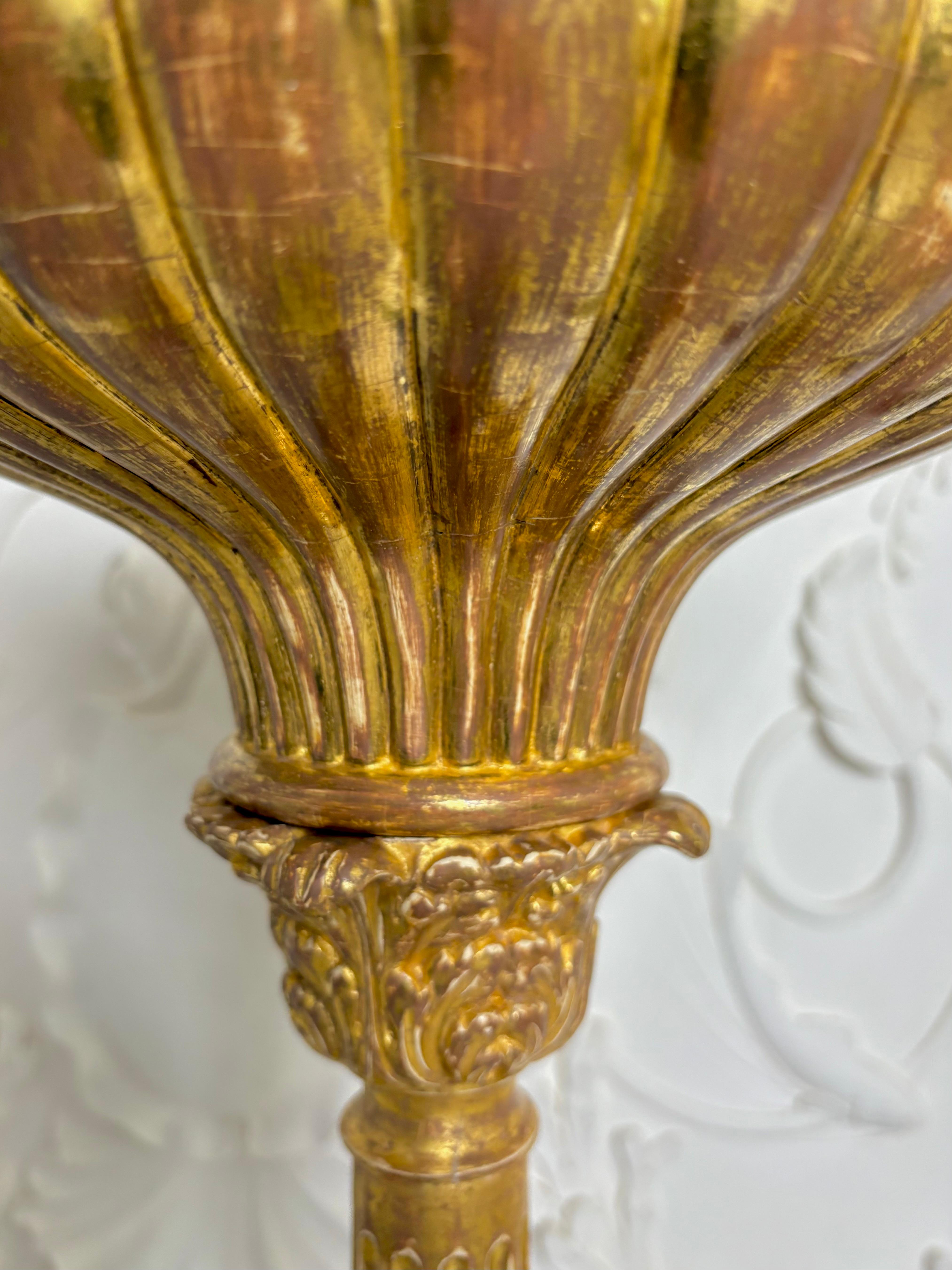 A large pair of late 18th Century Russian Torchieres with exquisite water gilding, an intricate impressively carved detail. The circular top slife leaf detail around trumpet shaped fluted moulding. Sits on a decoratively carved collar of acanthus