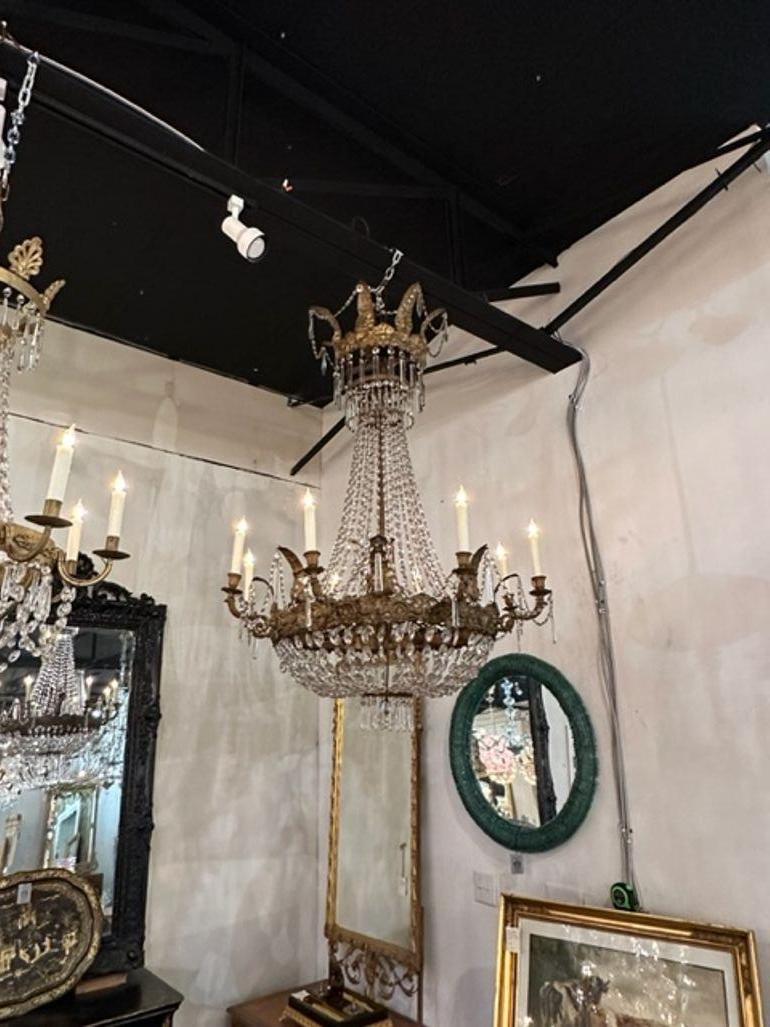 Exquisite 18th century large scale Italian Empire style gilt tole and crystal chandelier with 8 lights. An impressive fixture that is a classic beauty. Gorgeous!