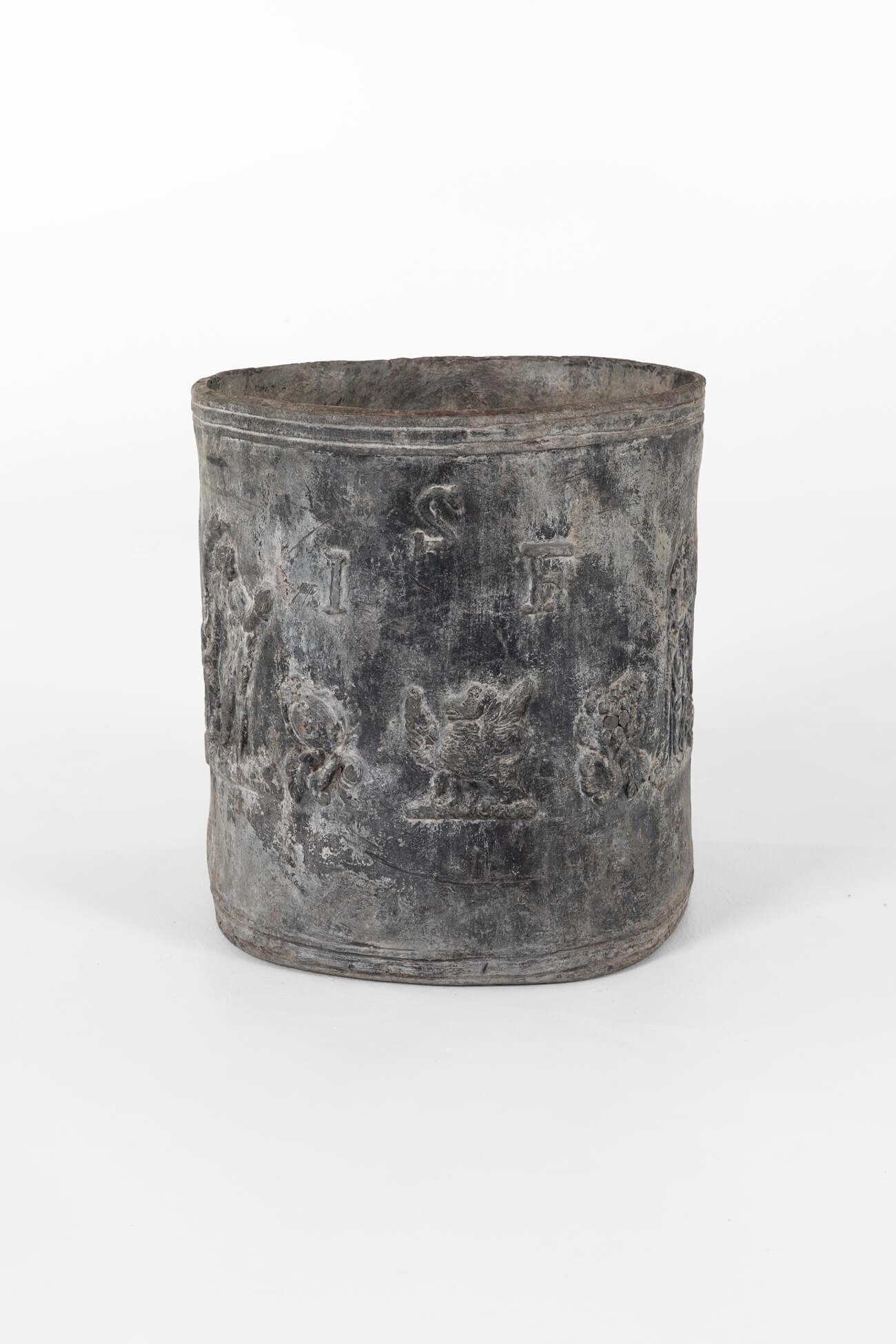A splendid late 18th-century large lead cylindrical planter.

The sides of the planter display scenes of classical figures and flowing vines with a central eagle motif on one side. The other side displays the initials I.S.F which almost certainly