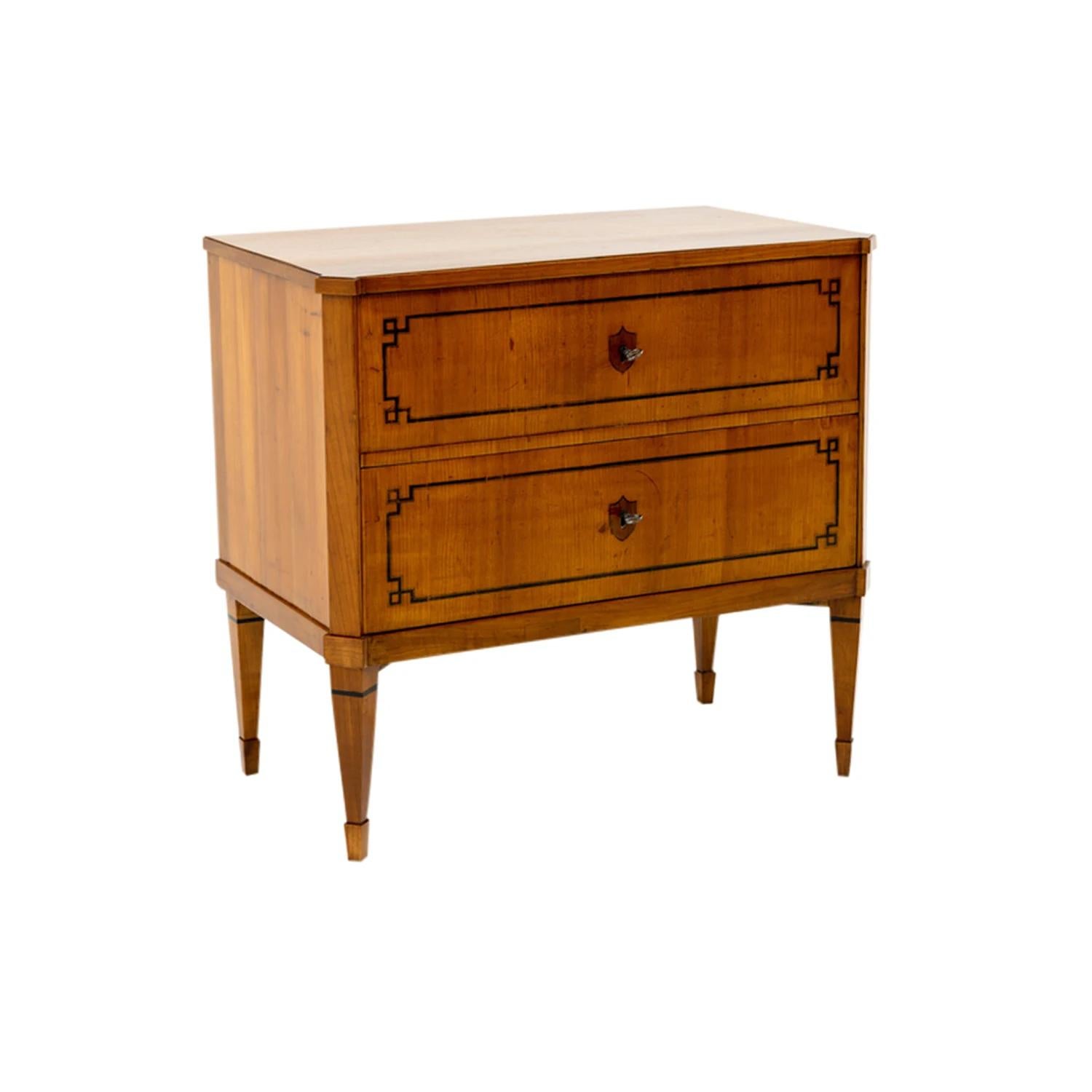 A light-brown, antique Austrian single commode with bevelled corners made of hand crafted veneered Cherrywood, in good condition. The rectangular polished chest is composed with two large drawers, standing on four square long legs. The front part of