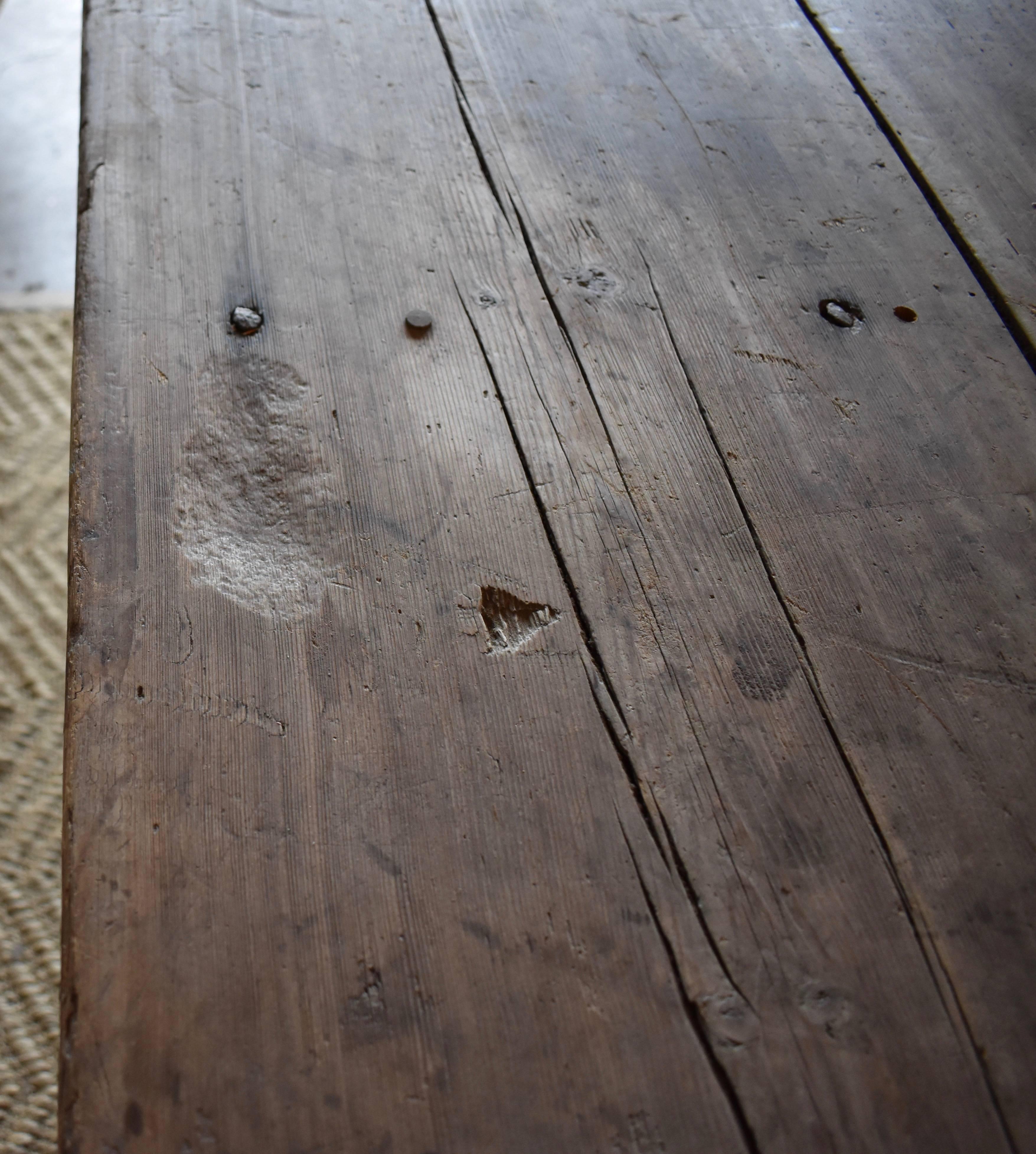 18th century Long Swedish Farmhouse trestle dining table. Great long size with original salt wells on the sides. One trestle side has been replaced. Old, but not original.