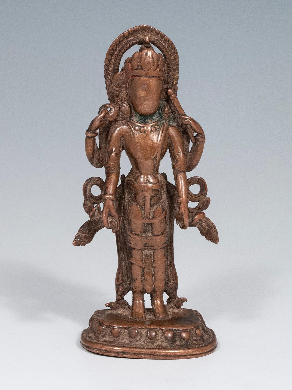 Vishnu figure
Nepal
Copper alloy
18th century or much earlier
5 1/8? (13 cm) high, 2 1/4? (5 cm) wide

A well-venerated copper statue of Vishnu, shown holding his four attributes: a club for divine power, a wheel symbolizing the sun, a conch
