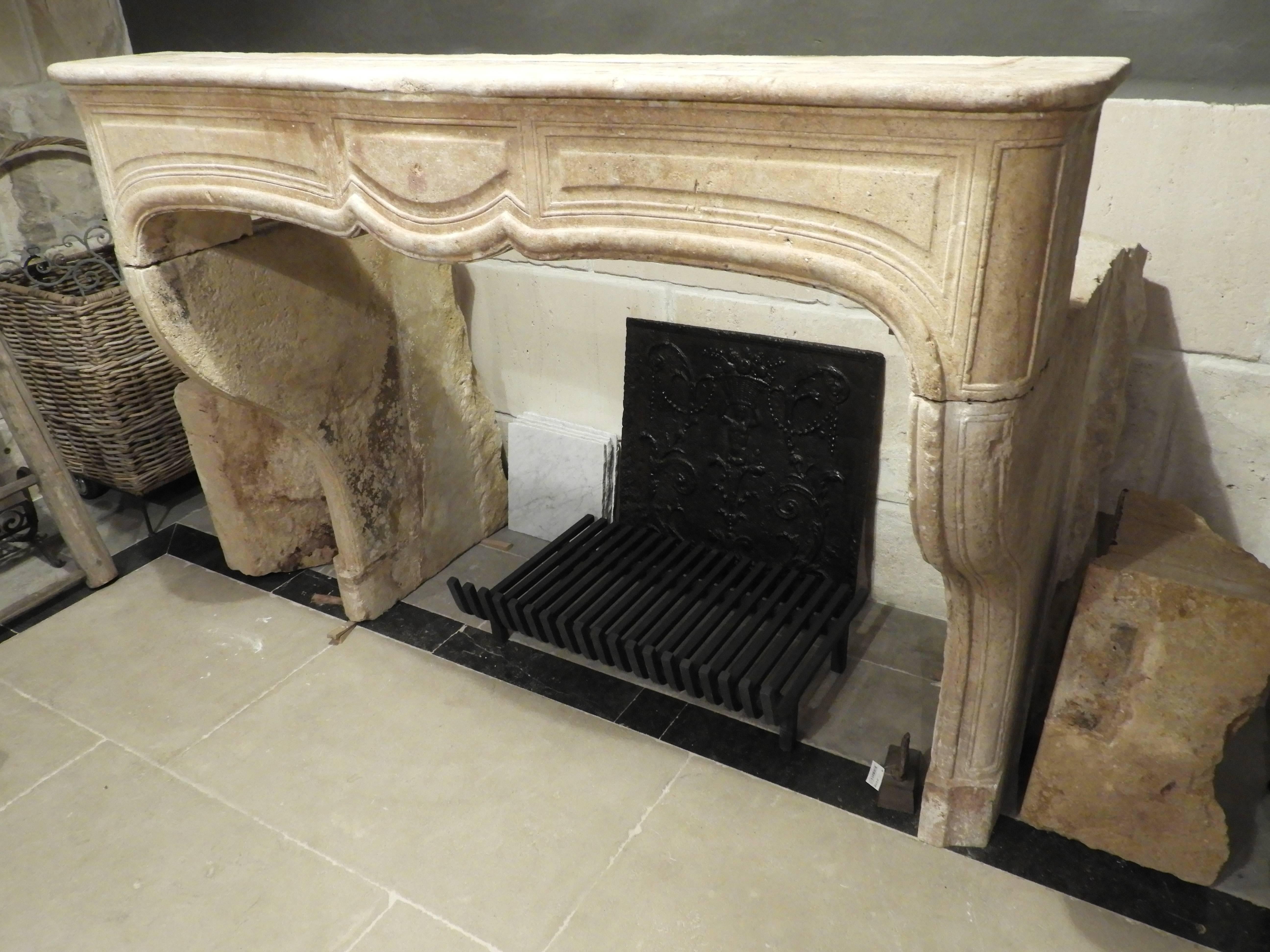 18th century Limestone Louis 15th fireplace in French limestone. The fireplace has a war beige/brow, patine. The fireplace isn't over decorated and has a sober elegant look.
It has character and would fit in to a Classic, country or even modern