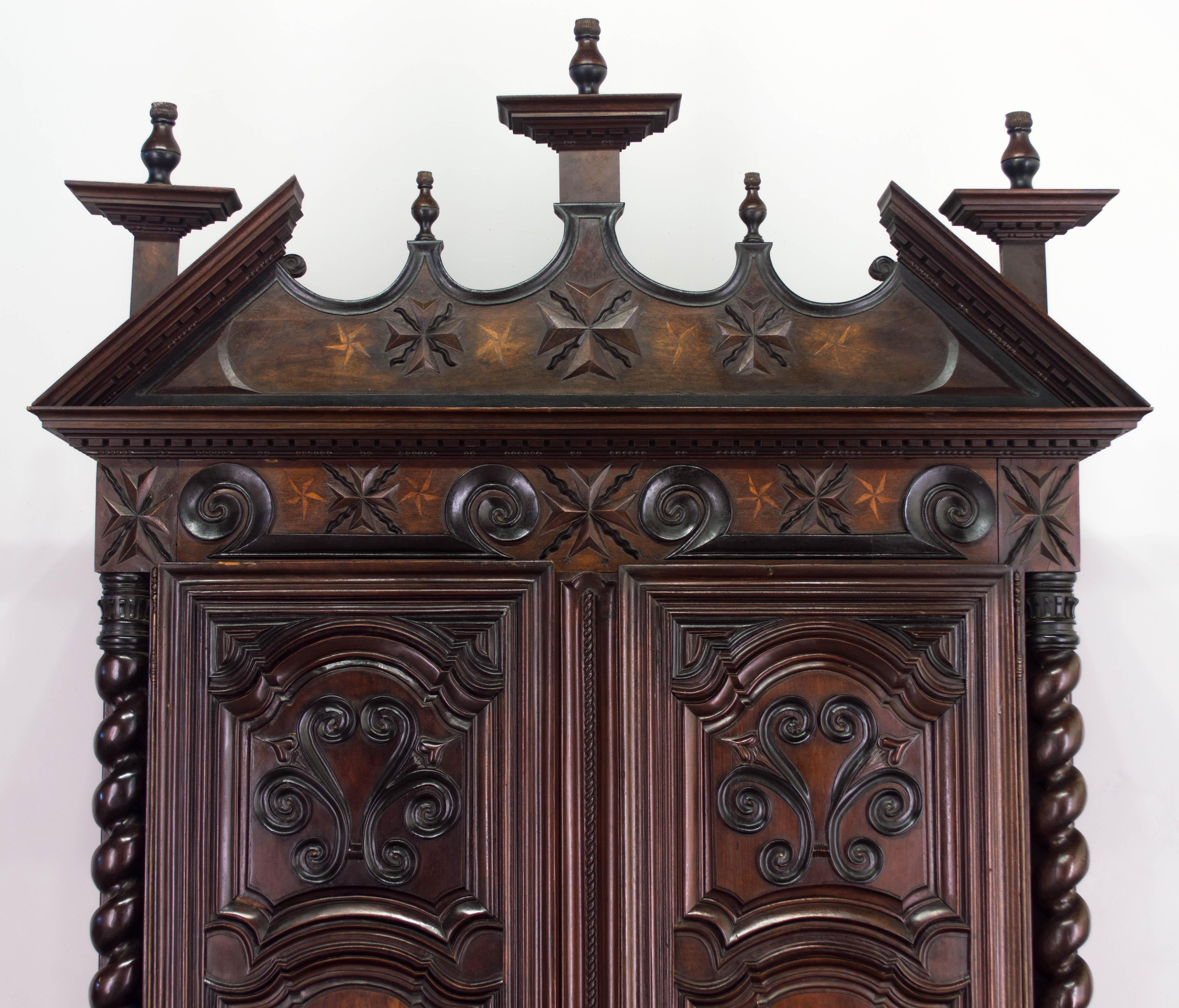 An exceptional Louis XIII style armoire from a chateau in the Southwest of France near the town of Agen. Made of various woods including ebony, lemon and walnut. Magnificent hand-turned twisted columns. Raised panel doors with inlaid details.