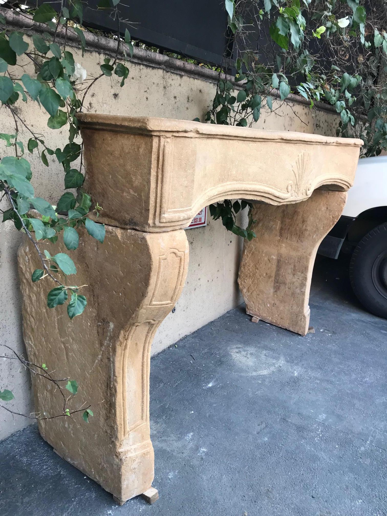 Hand Carved stone Antique Farm Fireplace Mantle Chimney Surround Los Angeles CA . A Rare 18th century unique original antique French Limestone fireplace mantel. this country fireplace surround in limestone known as 
