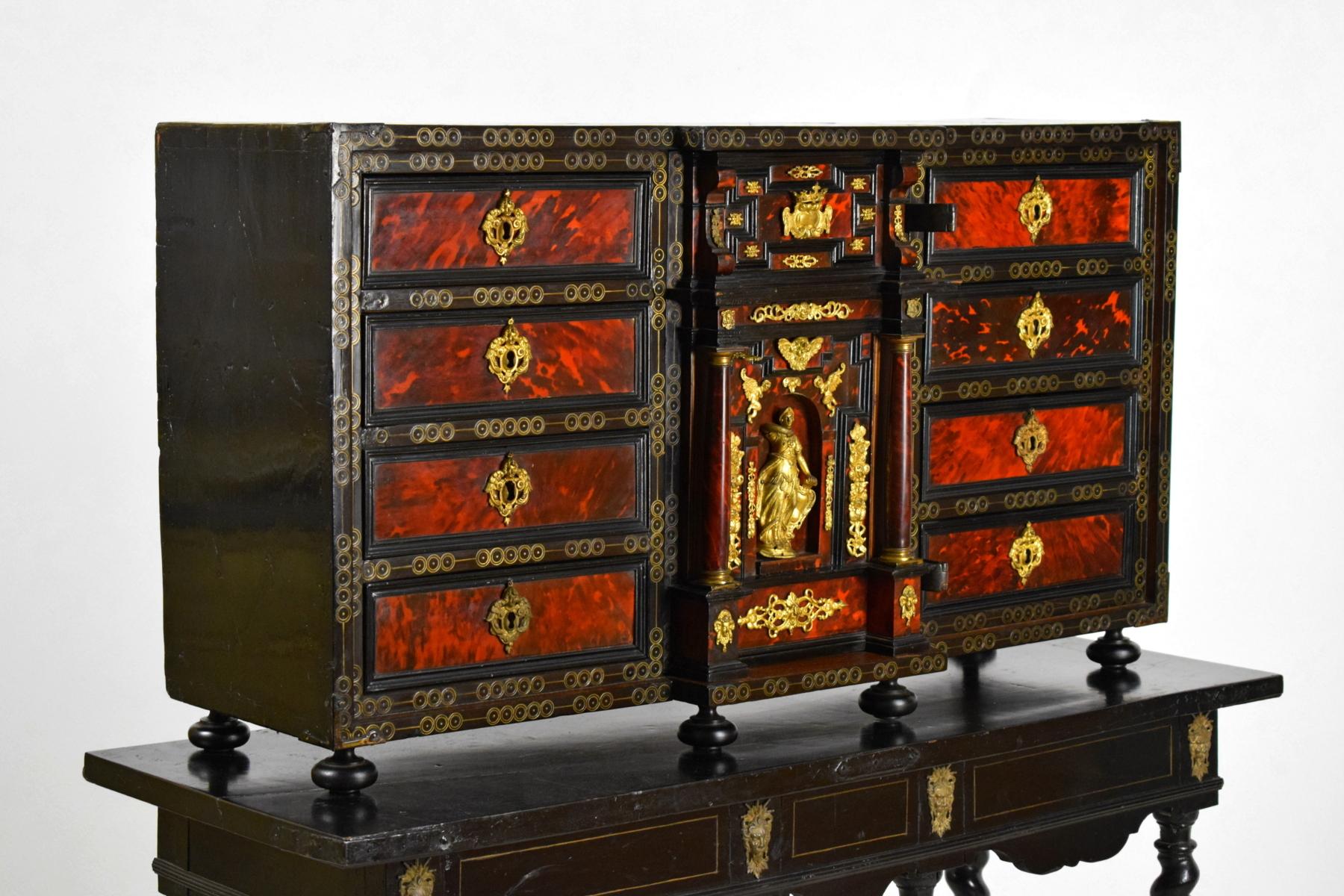 18th century, Louis XIV wood apothecary cabinet with gilded bronze
Measures with base H 145 x 127 x 45 cm; only cabinet H 62 x W 114 x D 37 cm

This particular coin cabinet was made in the early 18th century in the north of Europe in dark wood,