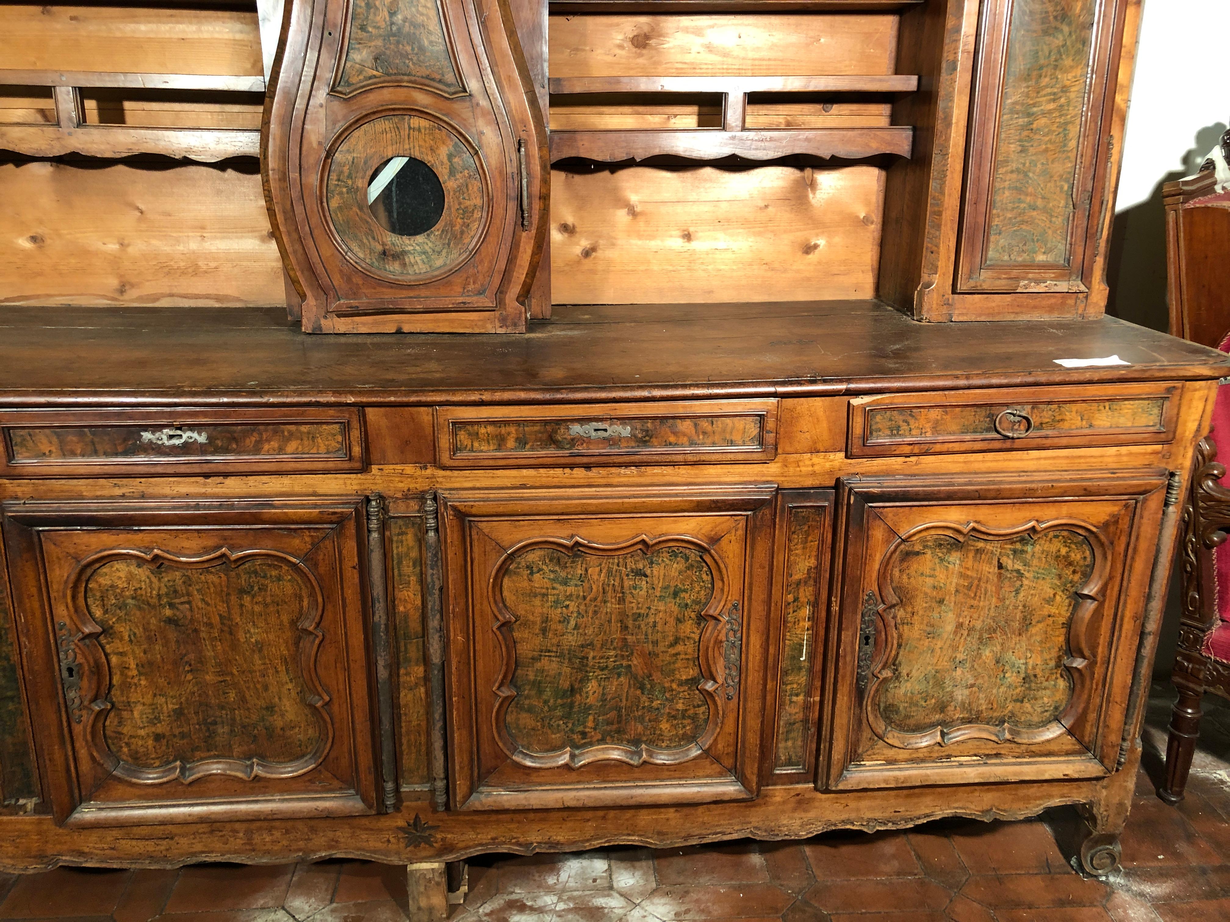 Provencal French buffet from 18th century, cabriole legs, four doors, with Morbier clock. In walnut and walnut root wood.
Untested clock functionality, completely to be restored, to be imagined finished, fantastic furniture.
 