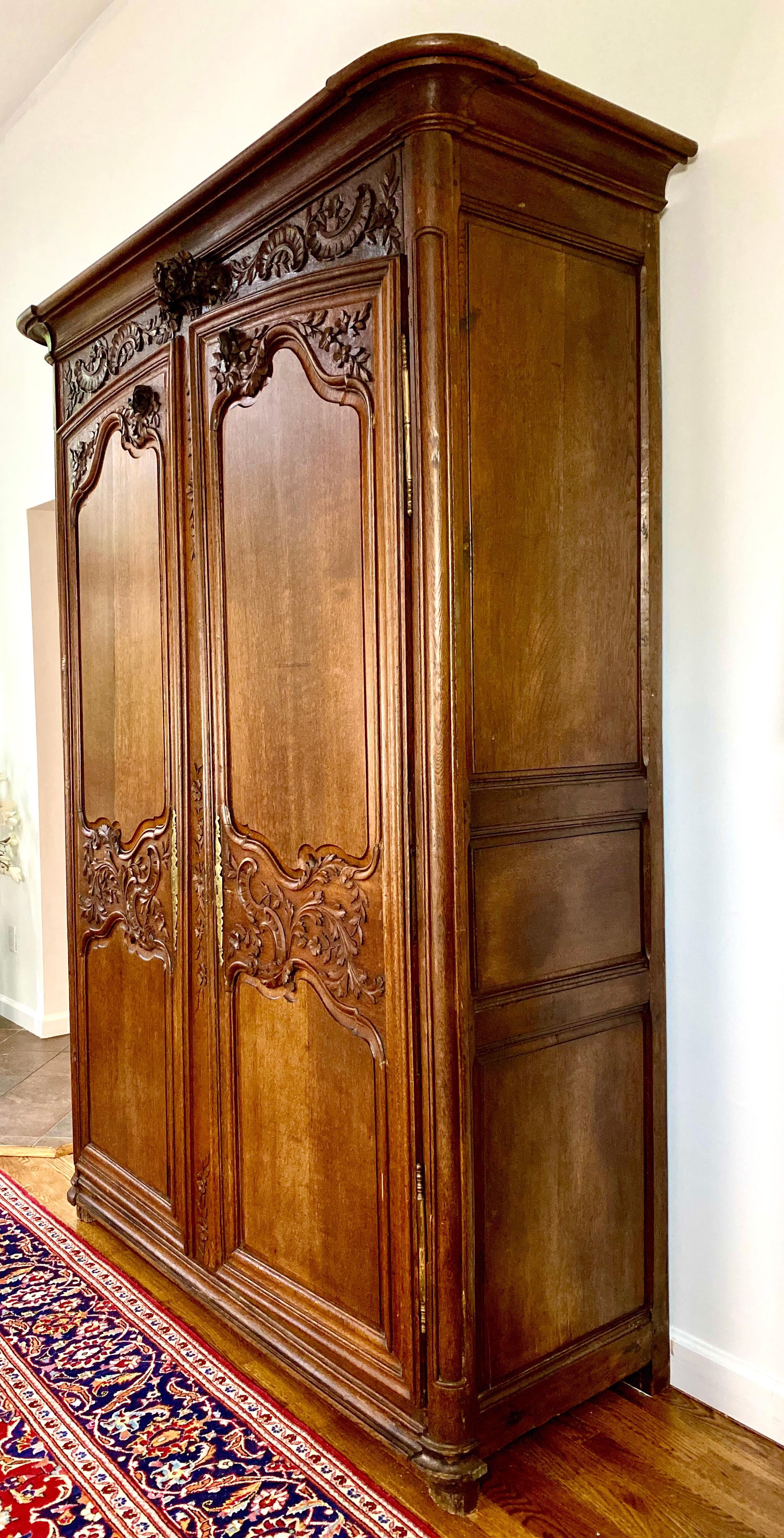 The French custom of a father's gift to his newborn daughter was the crafting or purchase of an armoire carved with symbols of plenty and happiness, which stored her trousseau to use in her own home once she married. This beautifully hand carved,