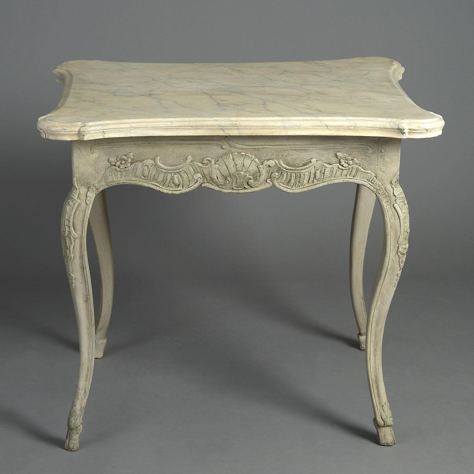 The serpentine top decorated with faux marble paintwork above a frieze carved with Rococo scrollwork and shells raised on similarly carved cabriole legs terminating in hoof feet.