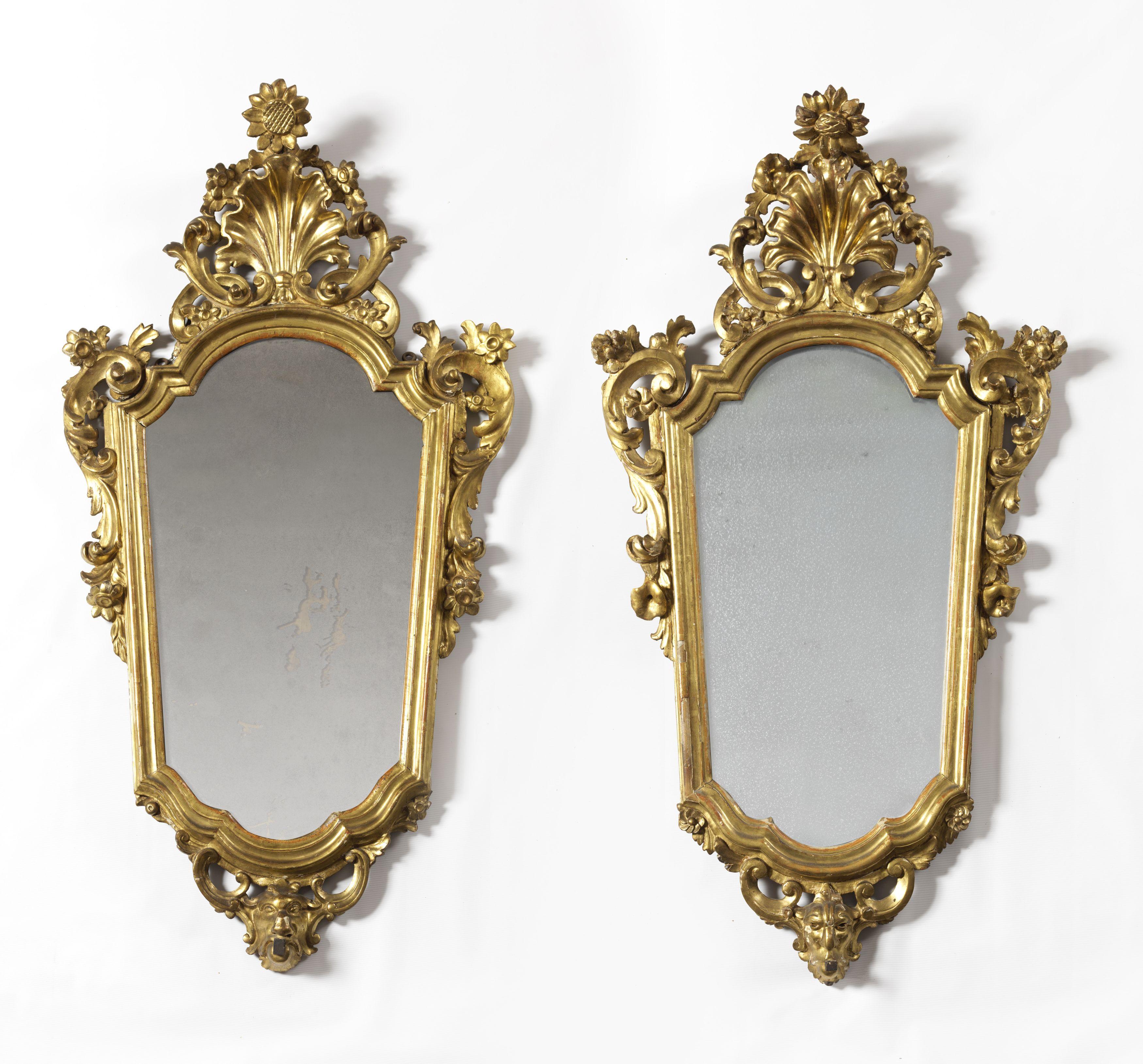 Refined pair of Lombard Louis XV mirrors measuring 95 x 55 cm from the first half of the 18th century, in carved, sculpted and gilded walnut with original 18th century mercury glass, with final coping and paws carved with scrolls and floral ribbons