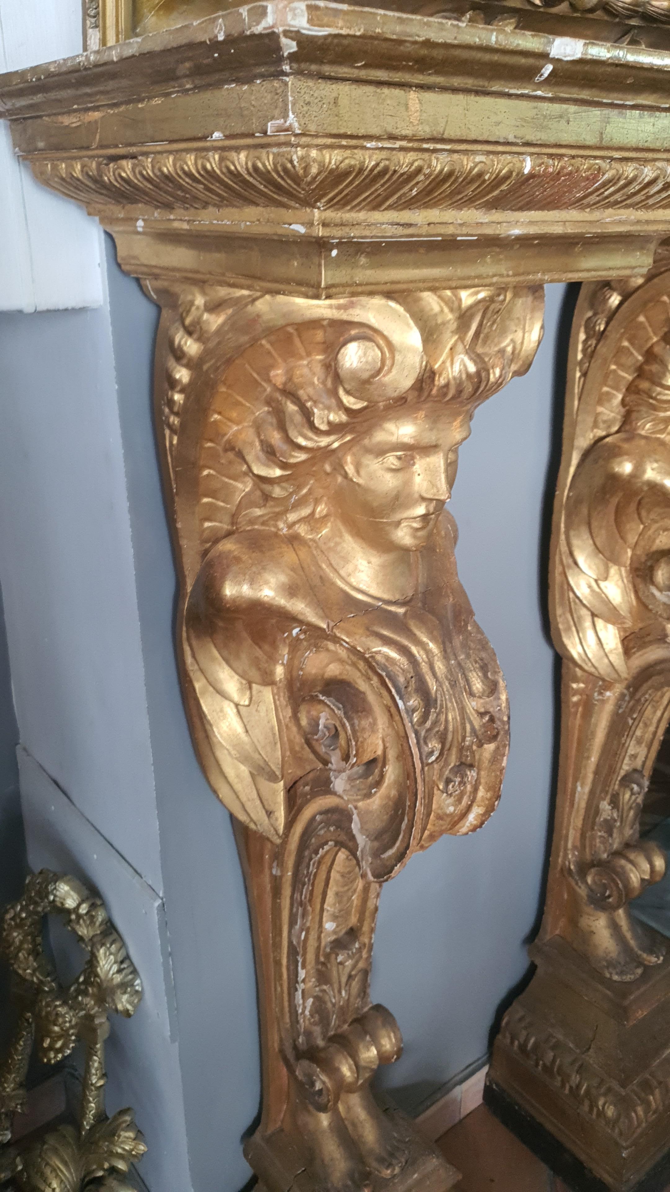 Rare and ancient pair of finely carved and gilded wooden pilasters with pure gold leaf.
