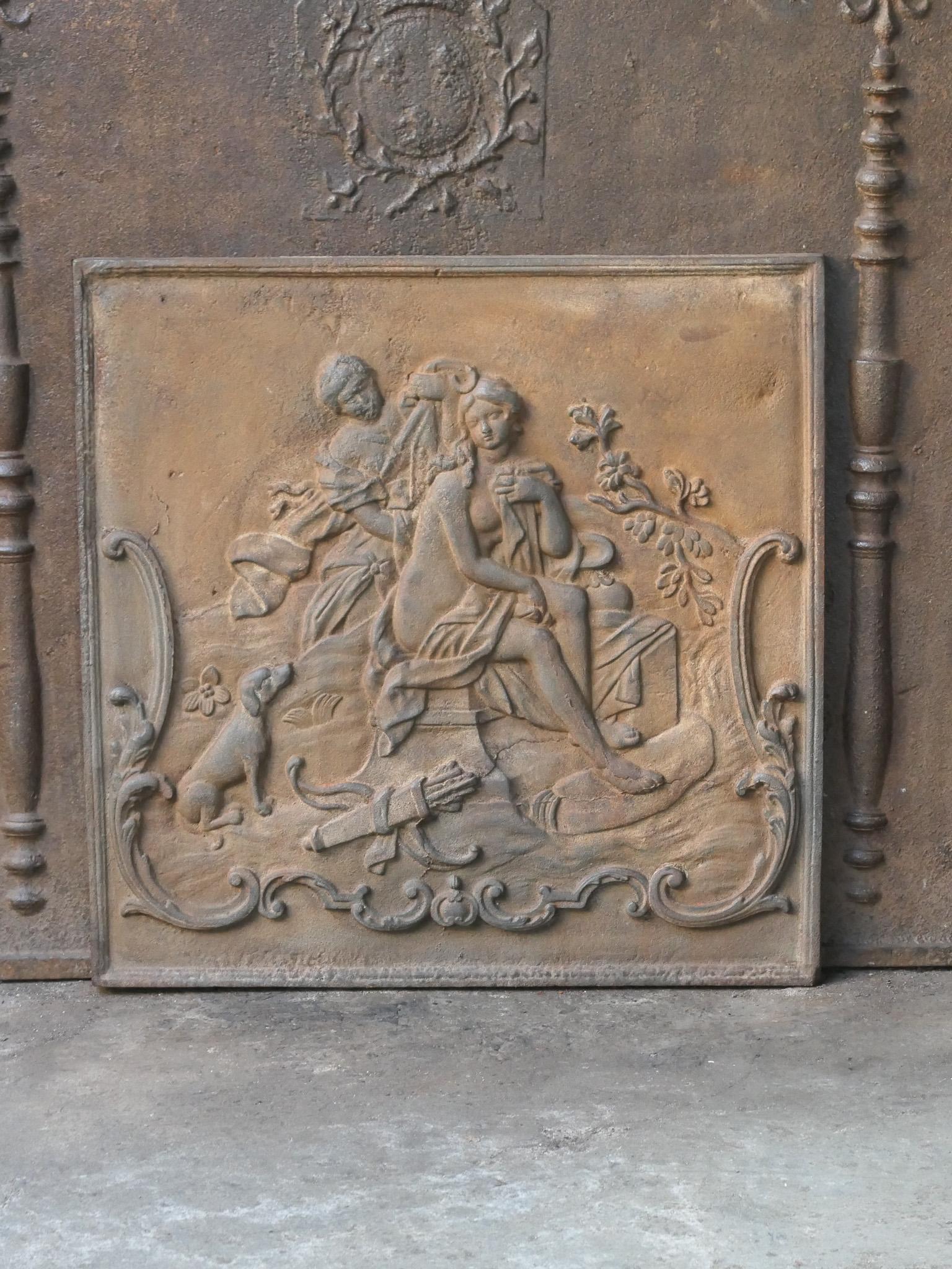 18th century French Louis XV period fireback with the Goddess Diana bathing.

Diana, Goddess of hunting, also protector of animals of the forest, especially the young animals. She experienced great pleasure in hunting, but took care that she did not