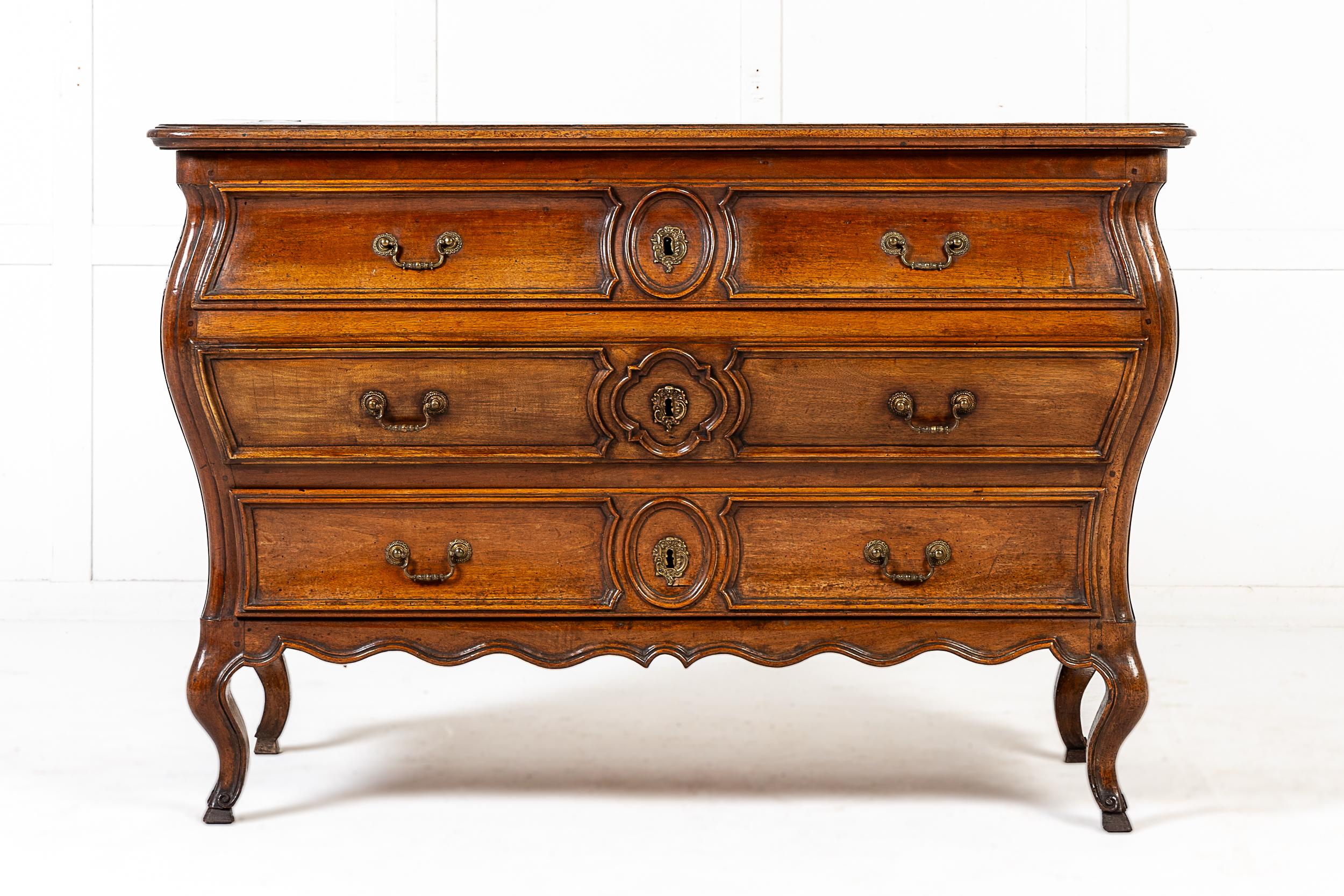 A Fine 18th Century French Provincial Louis XV Period Walnut Bombe Form Commode with Handsomely Inlaid Parquetry Top.

The Walnut commode of bombe form, but with an unusual rectangular top, inlaid with a starburst design in contrasting woods. The