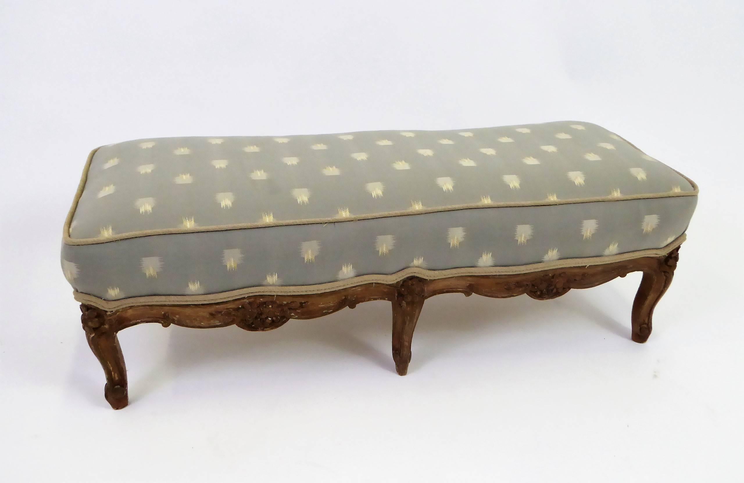 REDUCED FROM $950....Petite Louis XV carved wood footstool or low tabouret with cabriolet legs and floral carvings. Newly upholstered in a stylized woven chevron in beige and gold on a celadon grey green ground with beige linen welting. In original