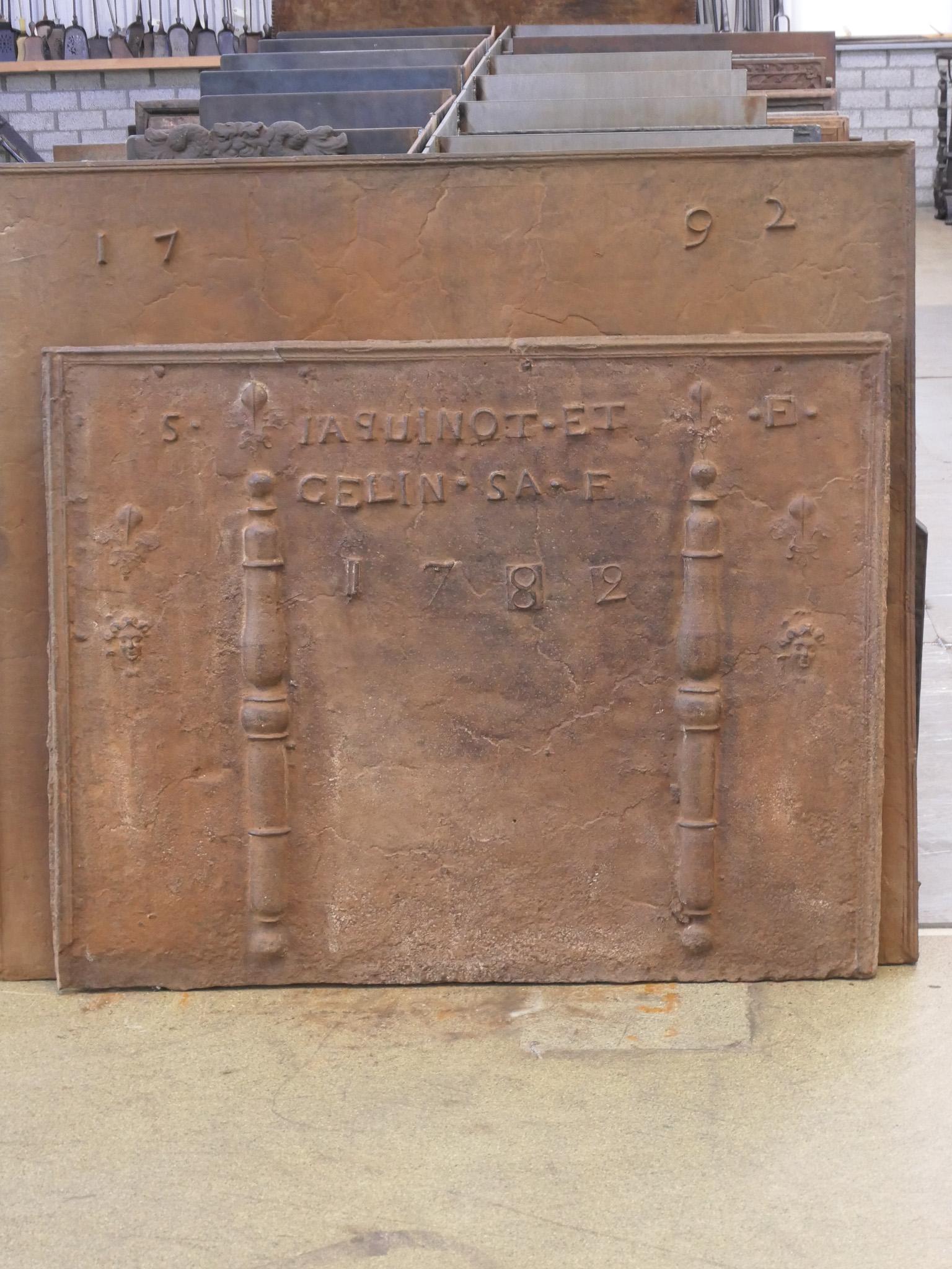Large 18th century French Louis XV period fireback with two pillars of Hercules that are topped with Fleurs de Lys. The Fleurs de Lys (French Lillies) symbolize the purity of nobility. As can be seen on the fireback, they were partially truncated