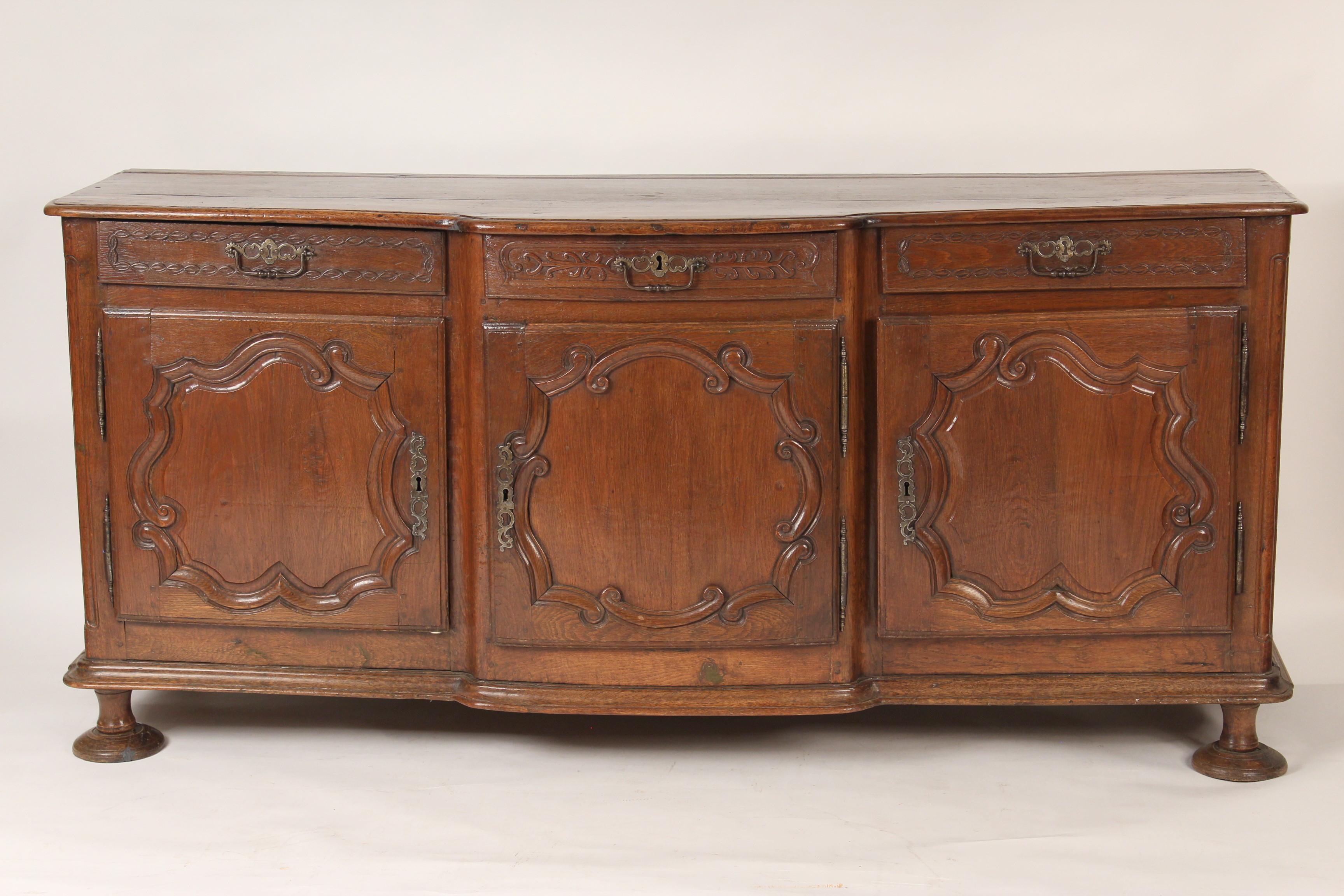 Louis XV provincial carved oak enfilade, 18th century. The wood has a nice old patina.