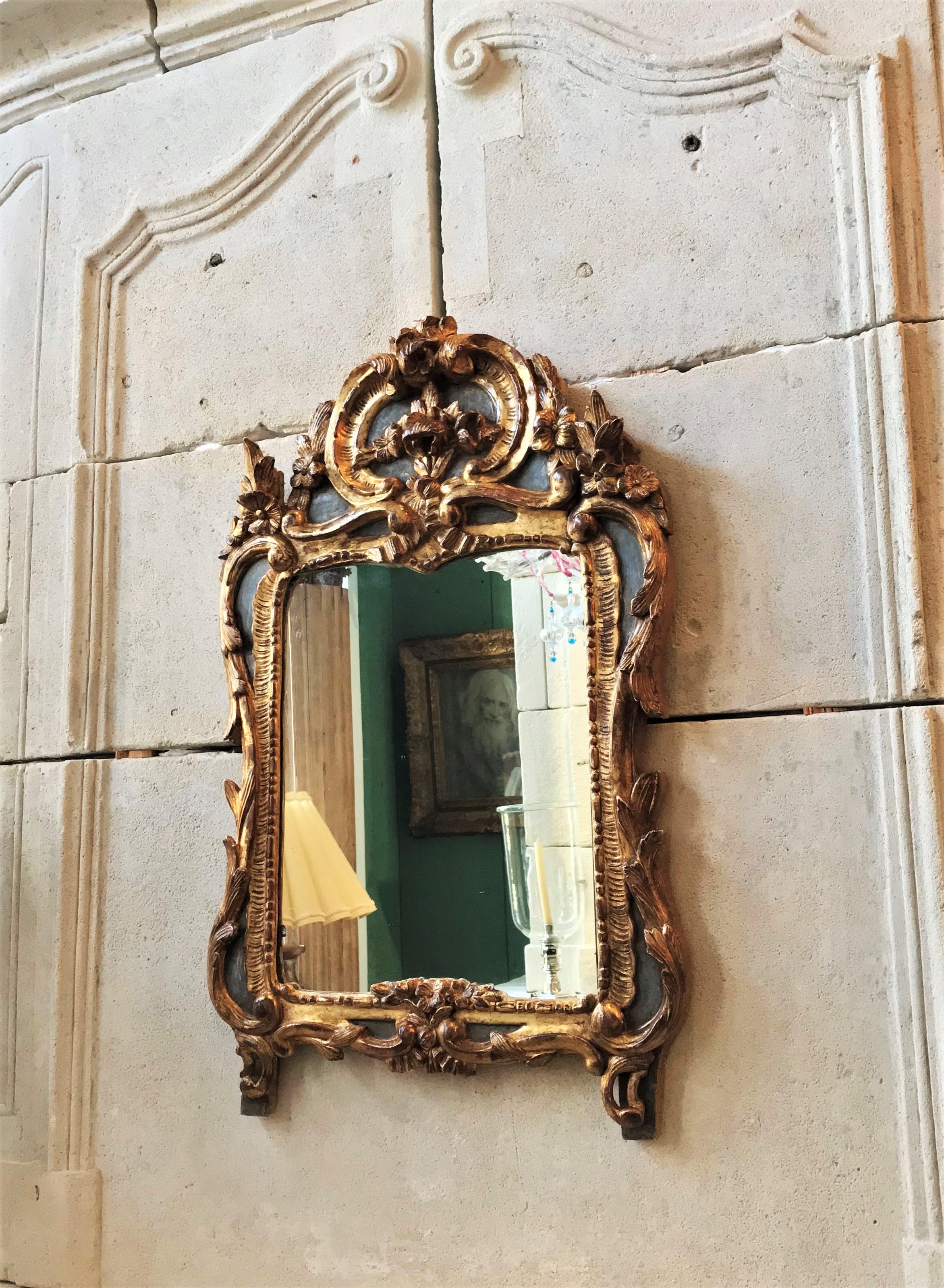 A superb Hand carved and gilded wood 18th century period Louis XV / French Regency  Regence rectangular framed antique mirror with it’s original carved decorative top sides and bottom, circa 1750, France. It's like a piece of Sculpture / Art to