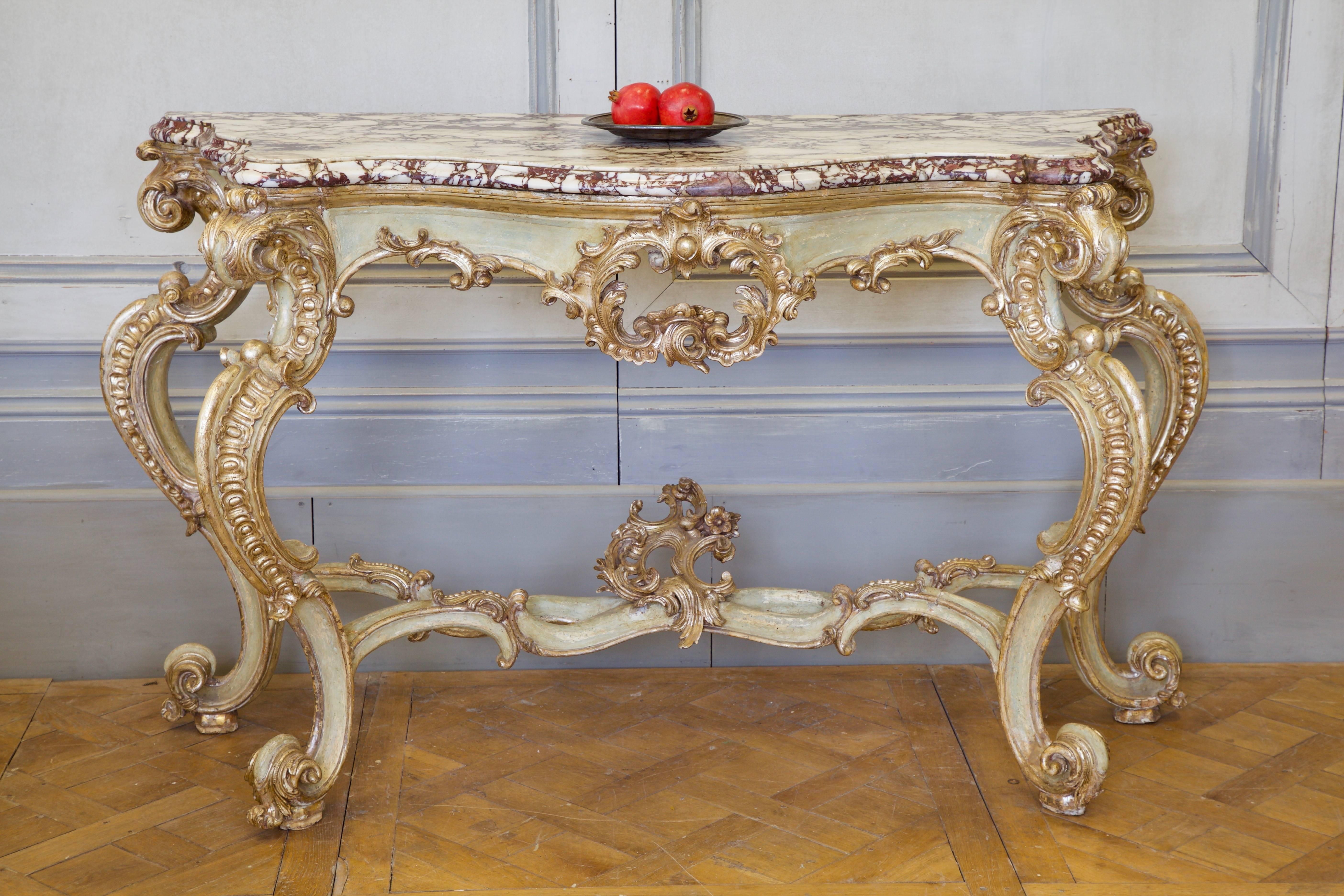 18th century LXV Italian console, impressively proportioned, featuring a statement, Breche Violet, bevelled marble top which makes a striking contrast to the naturally aged pistachio green patina, generously highlighted with silver gilding, all
