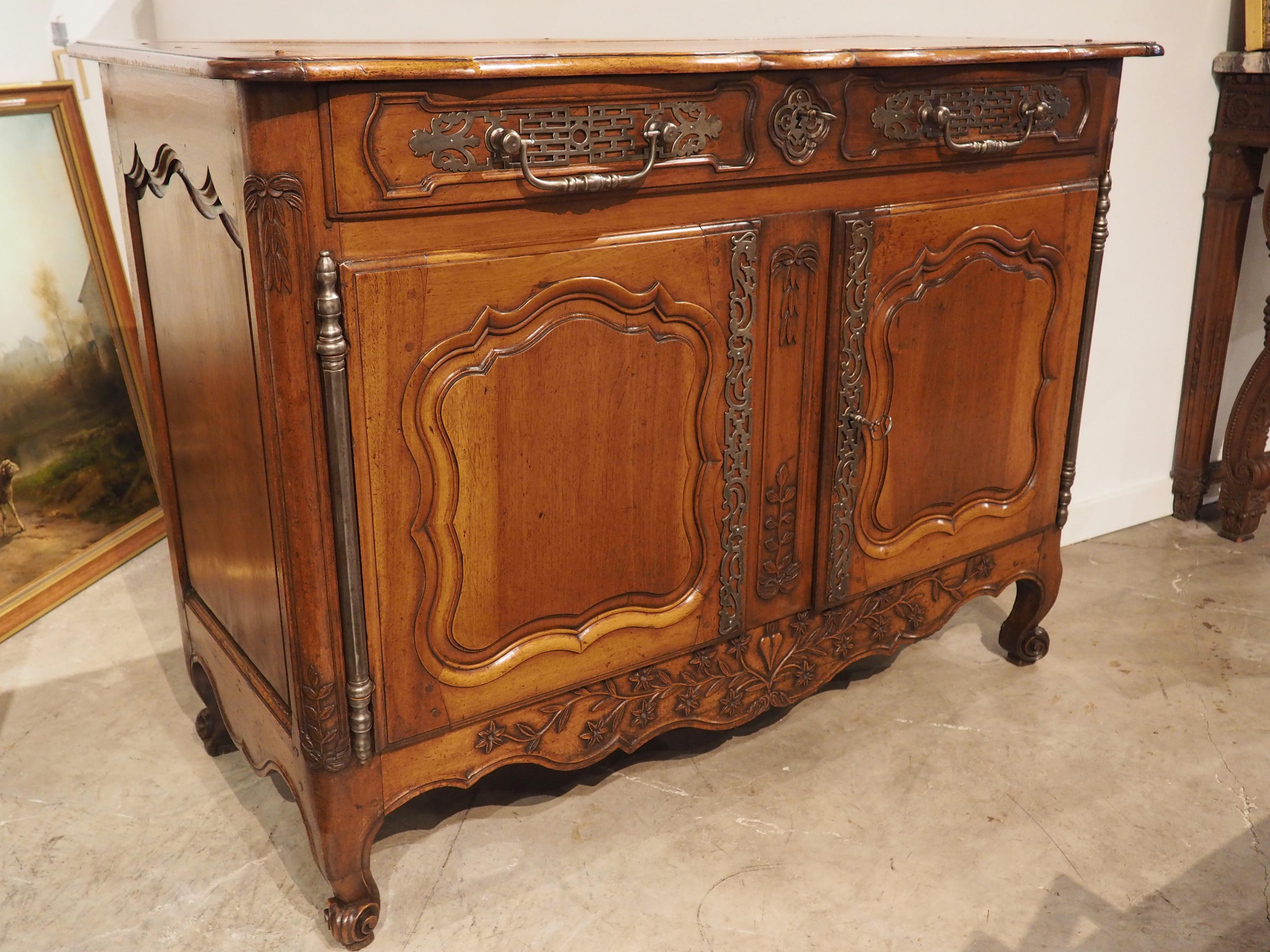 During the reign of Louis XV in the 1700’s, French menuisiers were skilled wood workers that specialized in solid-wood case storage pieces, such as this buffet from Provence. Hand-carved in walnut wood using round dowel construction, the exquisite