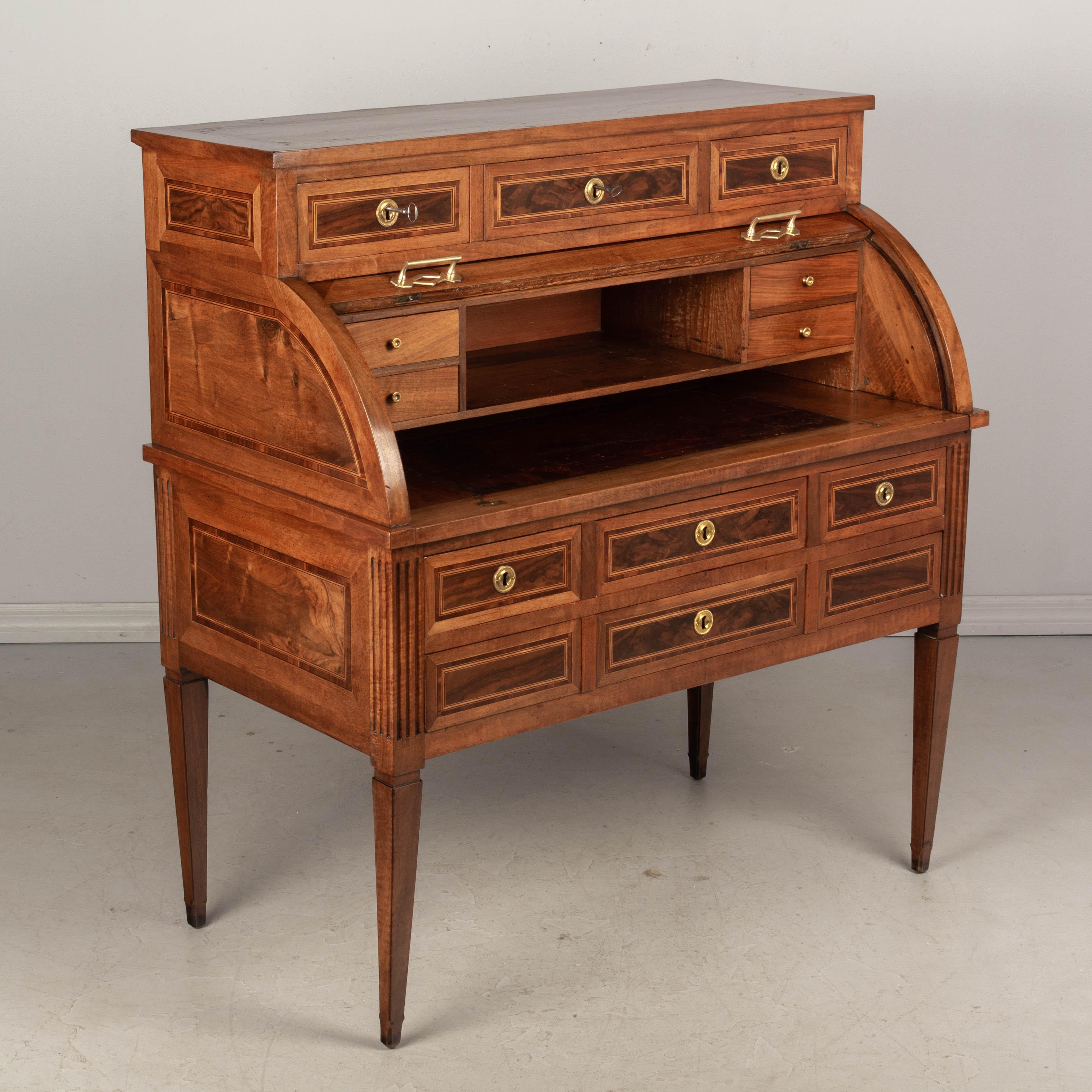 A fine 18h century Louis XVI period bureau à cylindre, or roll top desk, made of solid walnut with veneers of burled walnut, mahogany marquetry inlay and pine as a secondary wood. The surface of the cylinder is bookmatched burl of walnut veneer and