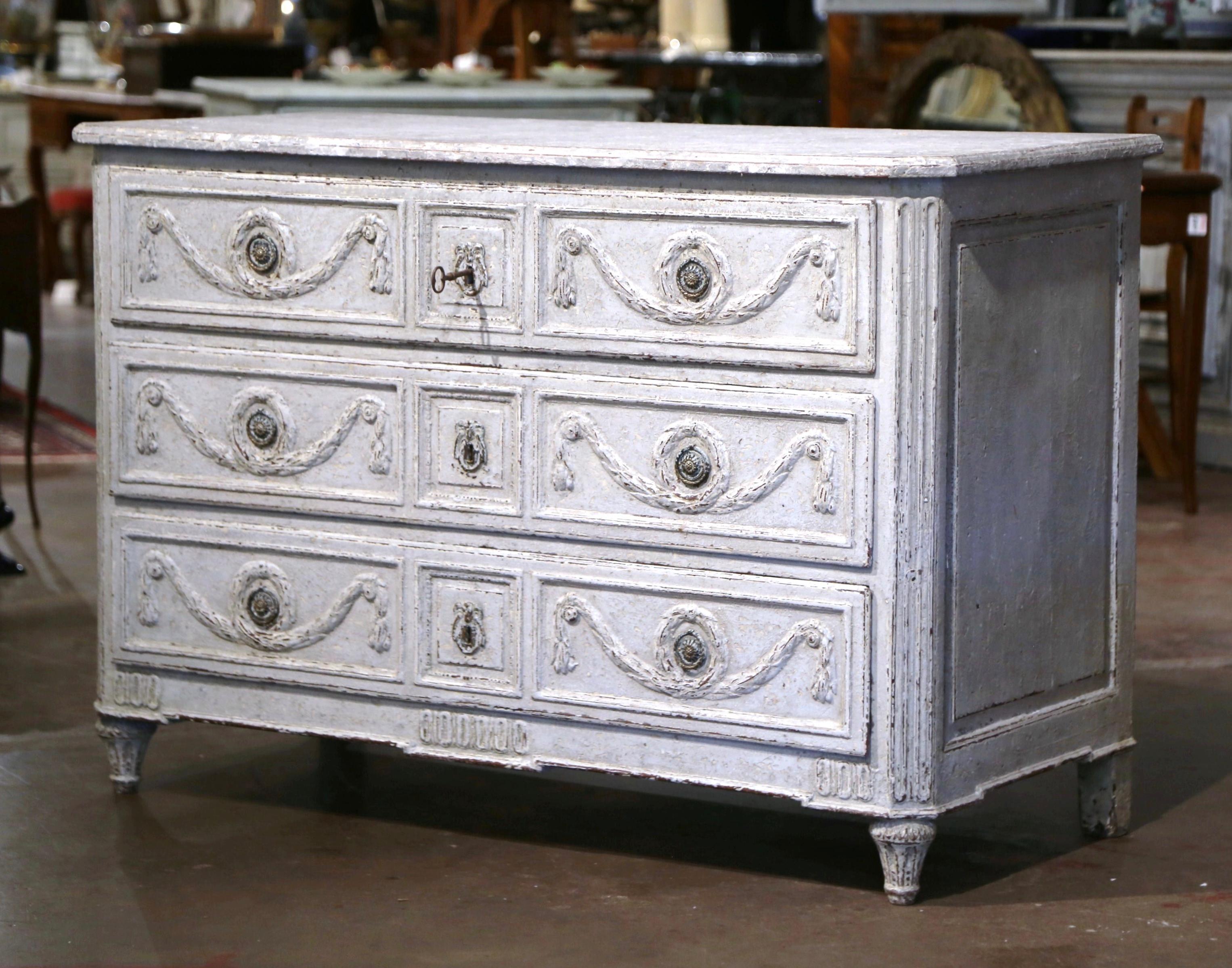 Decorate a bedroom or a living room with this elegant antique chest of drawers. Crafted in France, circa 1780, the cabinet stands on tapered and fluted feet over a straight apron decorated with geometric motifs. The commode with side spline columns