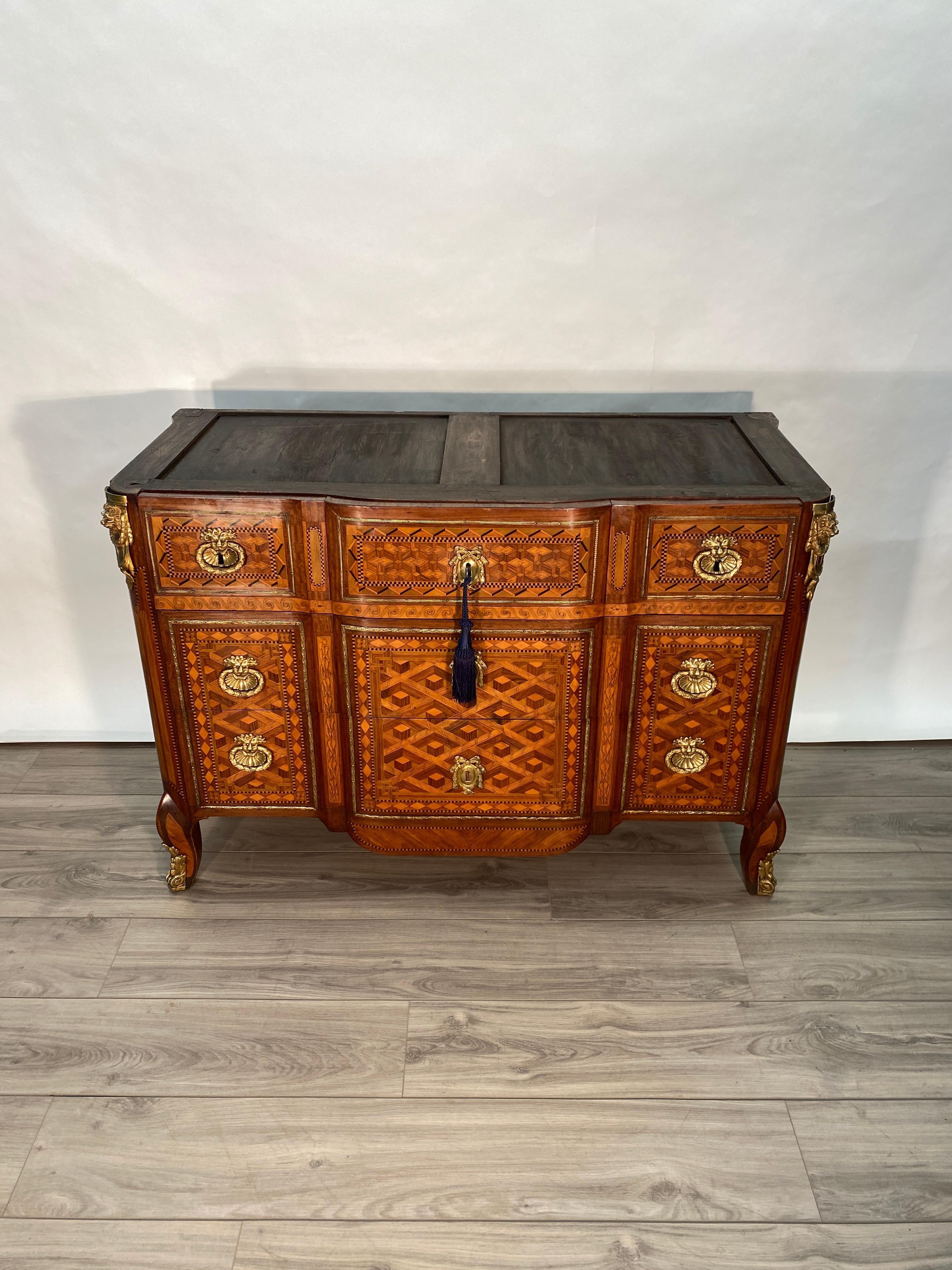 A very fine Period French Louis XVI Commode signed T.C. 
Oak and Walnut construction in the case and drawers. There are three upper drawers over two lower drawers. Heavy use of flowing parquetry inlay throughout the cabinet makes a stunning effect.