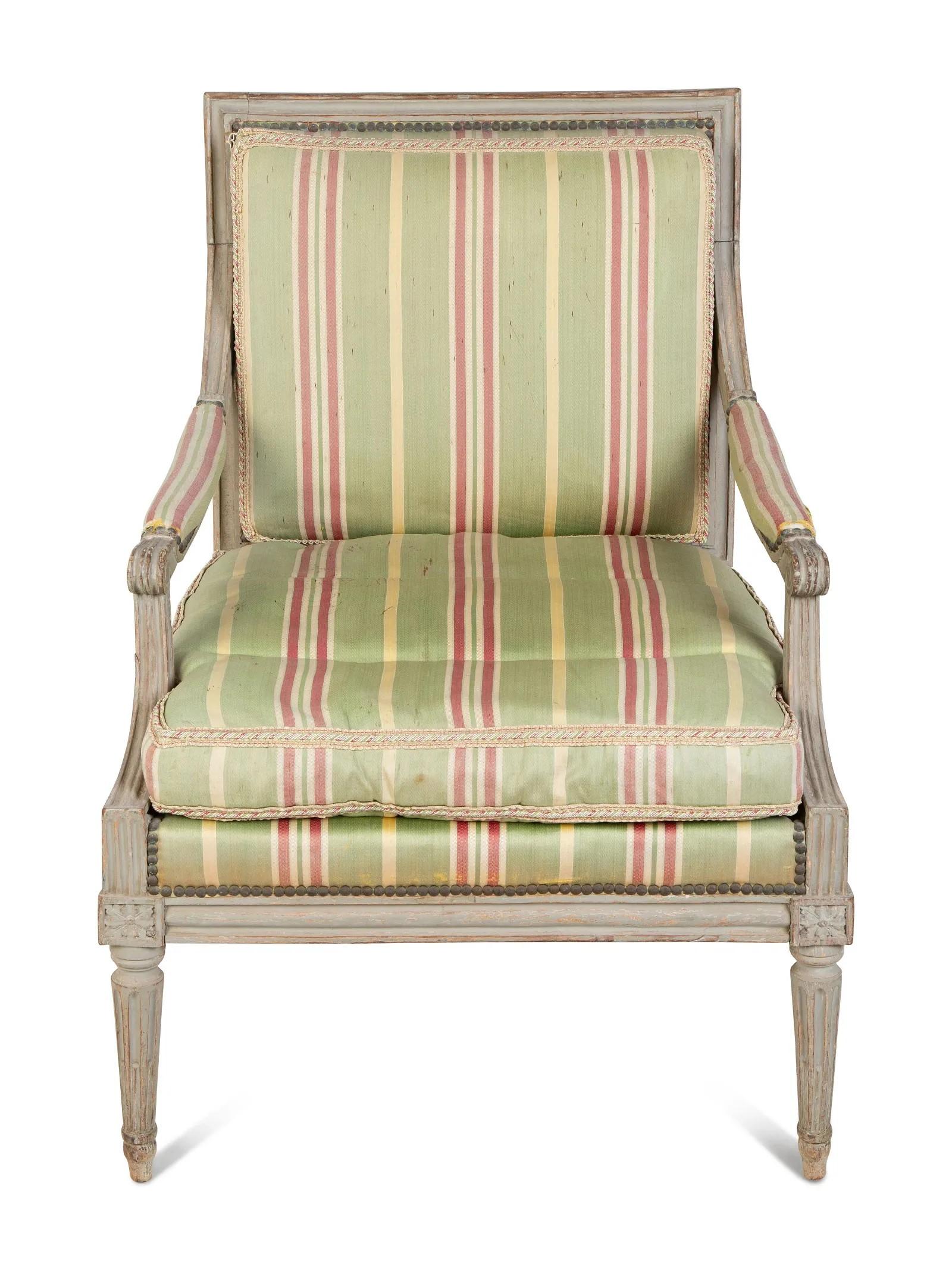 A fine Louis XVI painted fauteuil, French circa 1780, with upholstered seat and back, with molded frame and tapering fluted lags, pegged construction. Great patina.