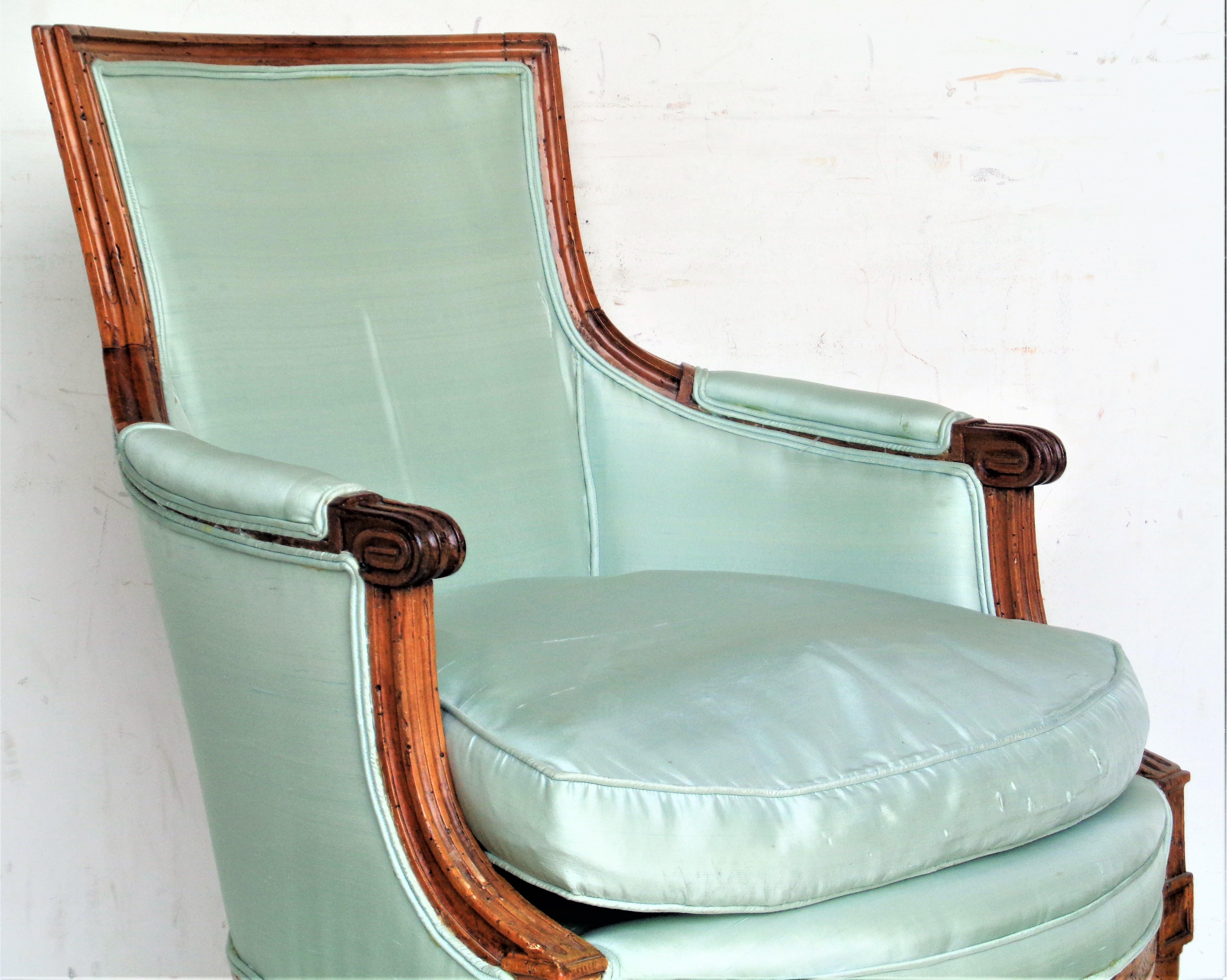 French 18th century Louis XVI carved fruitwood marquise / bergere in beautifully aged warm honey colored surface to wood. All original early construction. Vintage lightly worn pale mint green silk upholstery soft and plush. Look at all pictures and