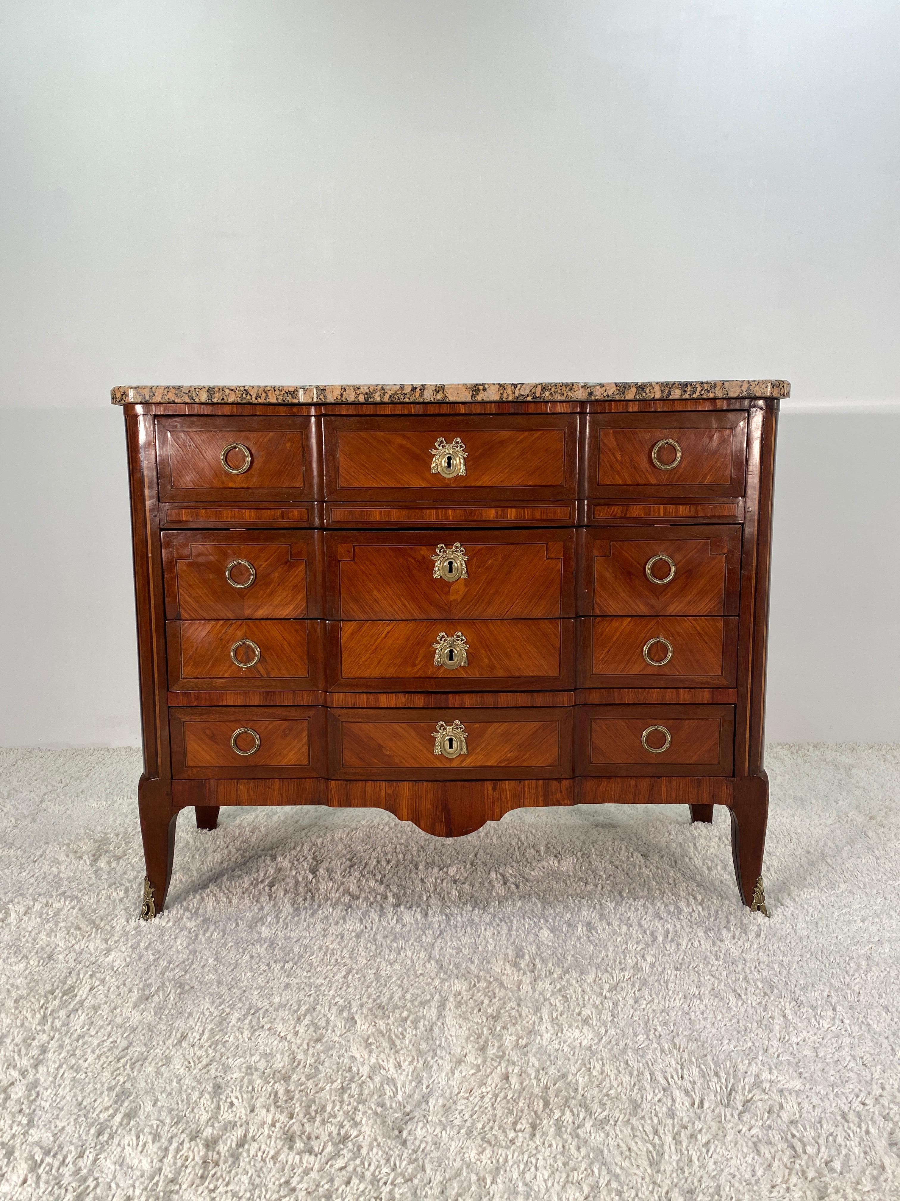 Louis XVI marble-top commode featuring Tulip wood, rose wood and King wood veneers throughout. Built using oak secondary woods. The highly polished granite marble top is in impeccable condition with no previous damage or repairs of any kind. The