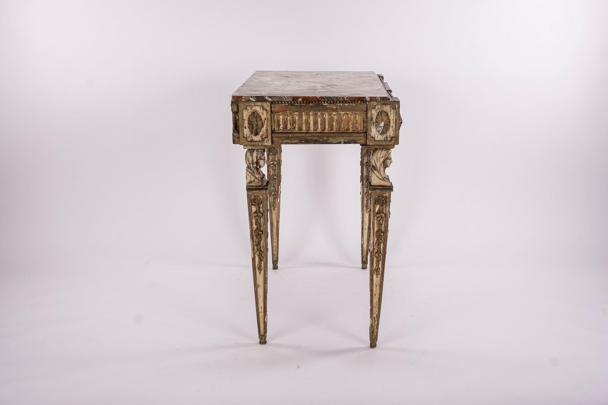 18th century French neoclassical console, giltwood and painted table adorned with exceptional carved busts, rosette and fluting. Sienna marble.


 