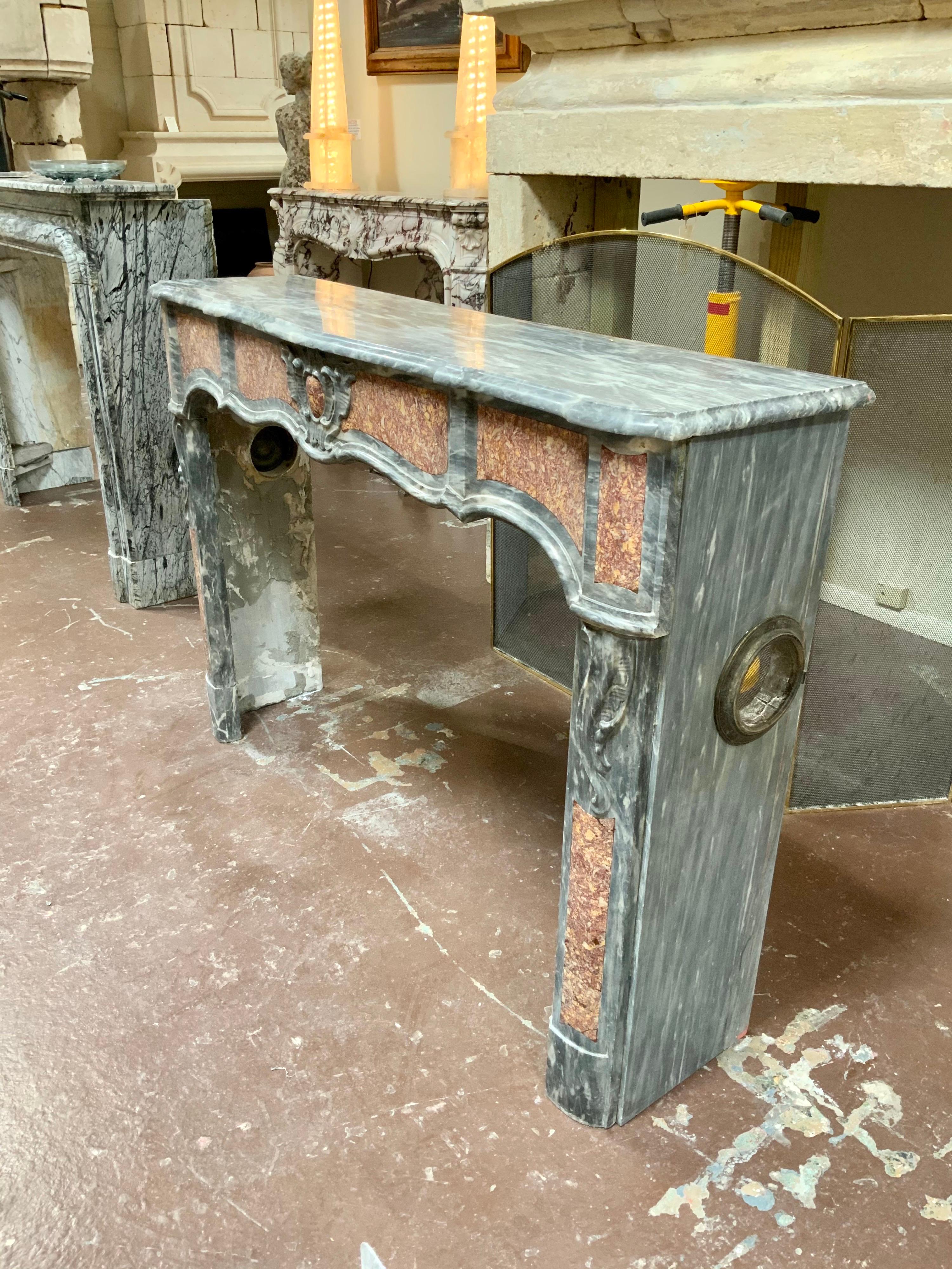 This Louis XVI mantel origins from France, circa 1780.

It has a shaped and molded shelf over an undulating molded and inlaid frieze on molded and inlaid legs ending with semi-rounded feet.

Firebox measurements: 49