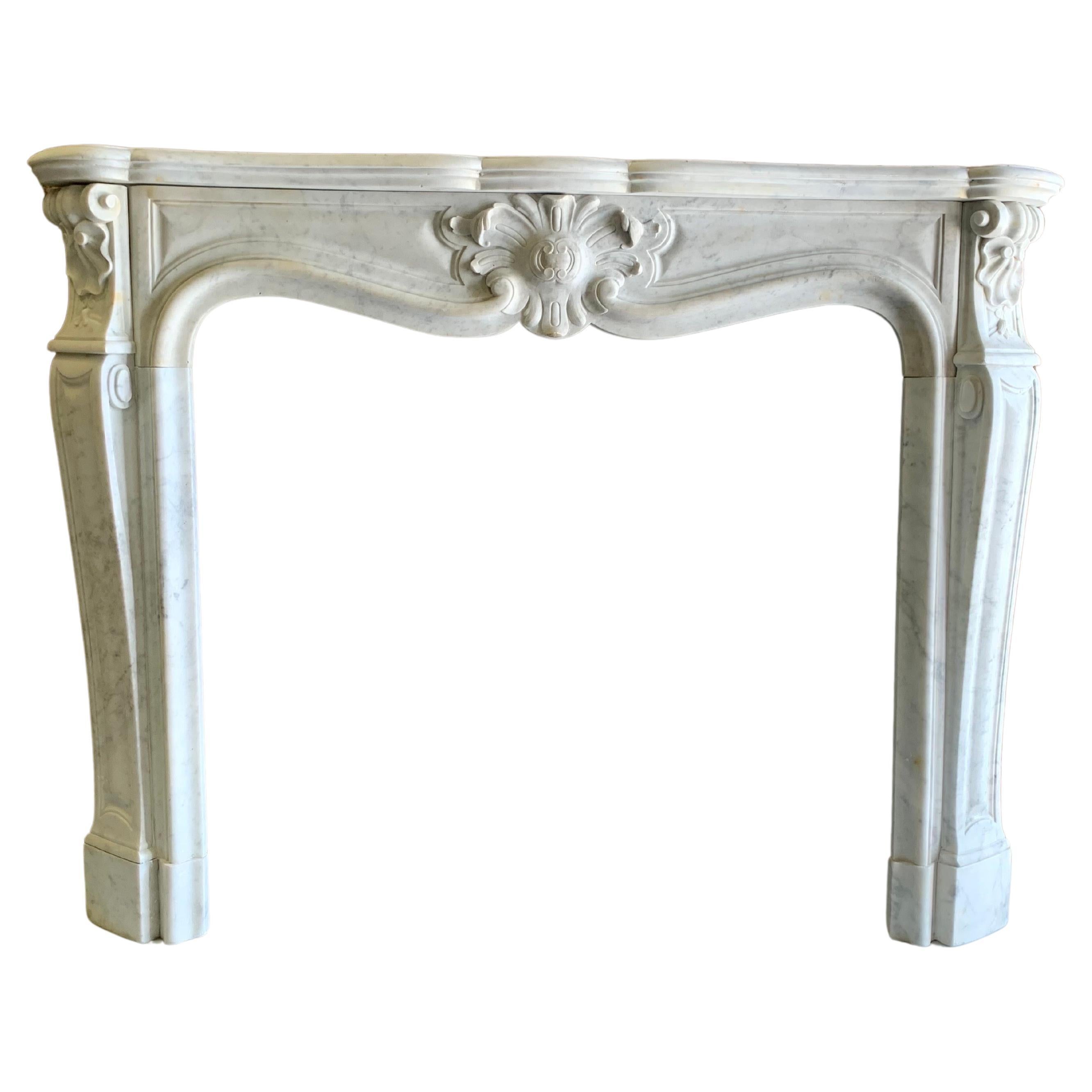 18th Century Louis XVI marble fireplace mantlepiece.
This beautiful Antique fireplace is hand carved from white italian statuary mable with detailed panelling to both Jambs & Centre Frieze. In addition to the fine carved undercut relief to its