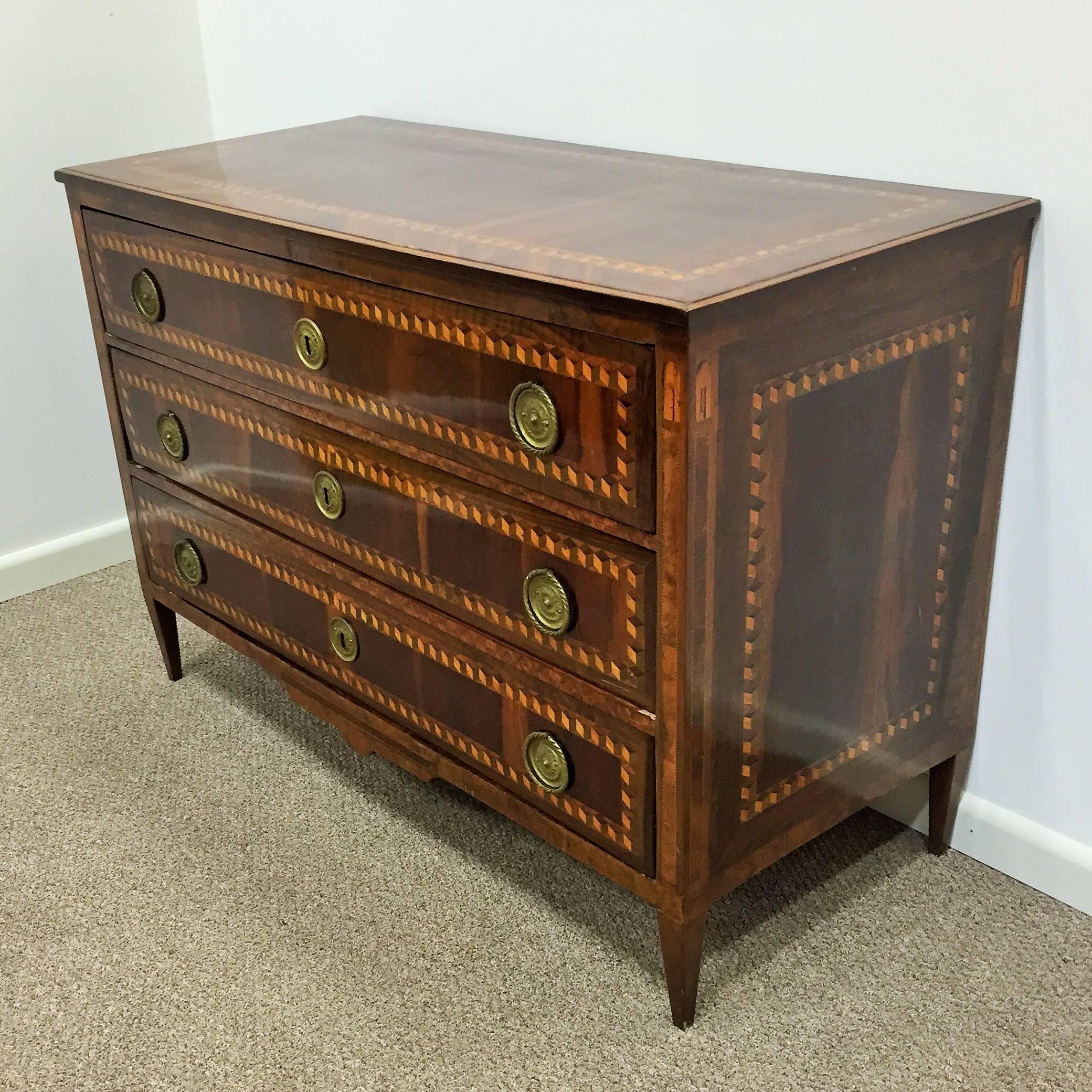 18th century Louis XVI marquetry commode or chest of drawers with tulipwood inlay veneer and oak and pine as secondary wood.