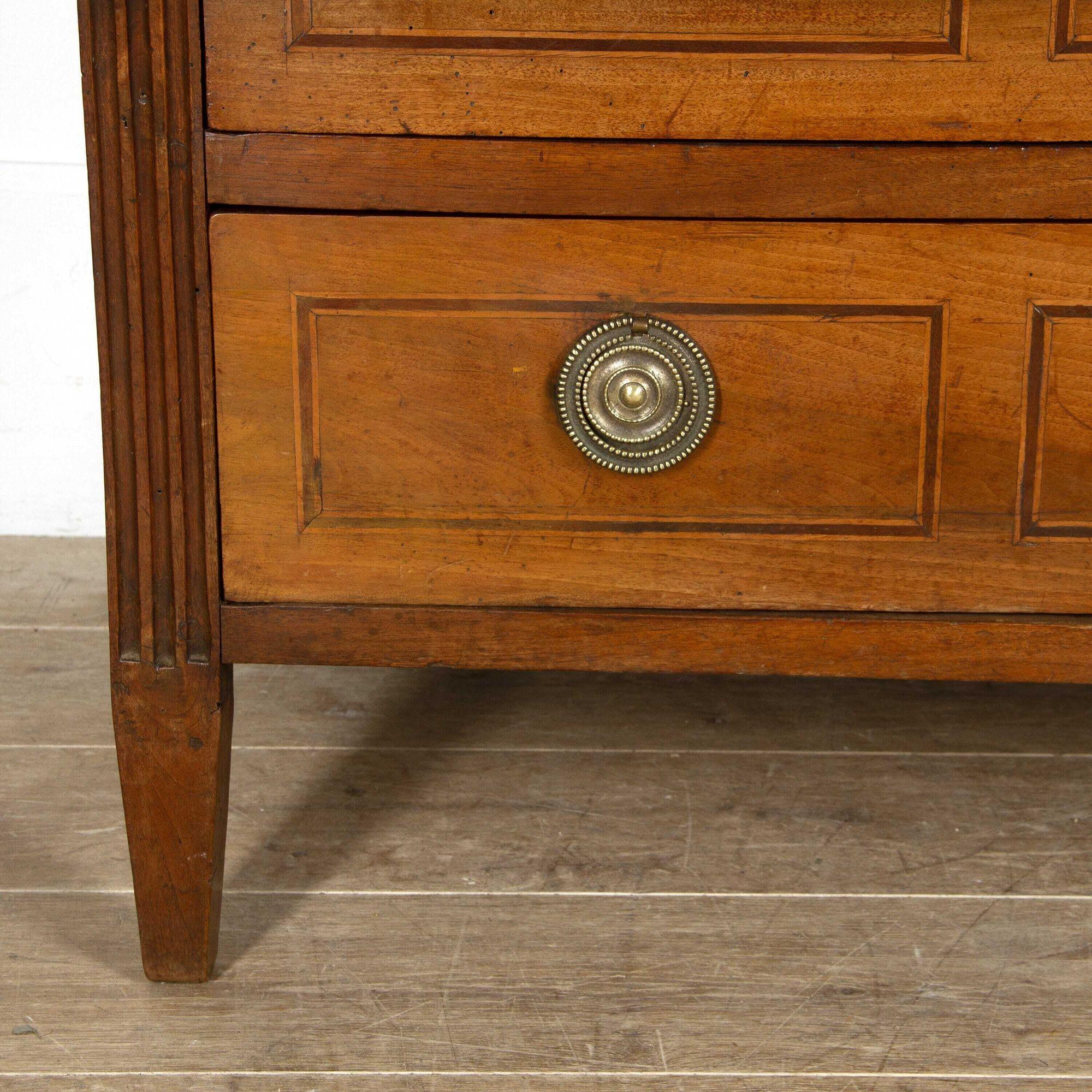 Beautiful walnut chest of drawers in the Louis XVI style. 
This wonderful chest has three drawers that are equal in size. Each drawer has its original bronze handles which are beautifully polished. 
It has decorative parquetry that has a fantastic,