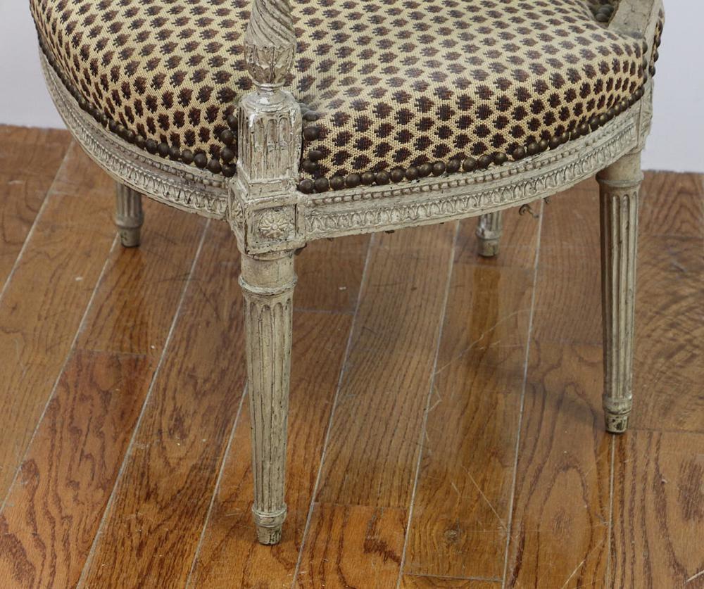 A fine French Louis XVI period fauteuil in old gray painted finish, upholstered in a woven wool fabric seat and back, marked 