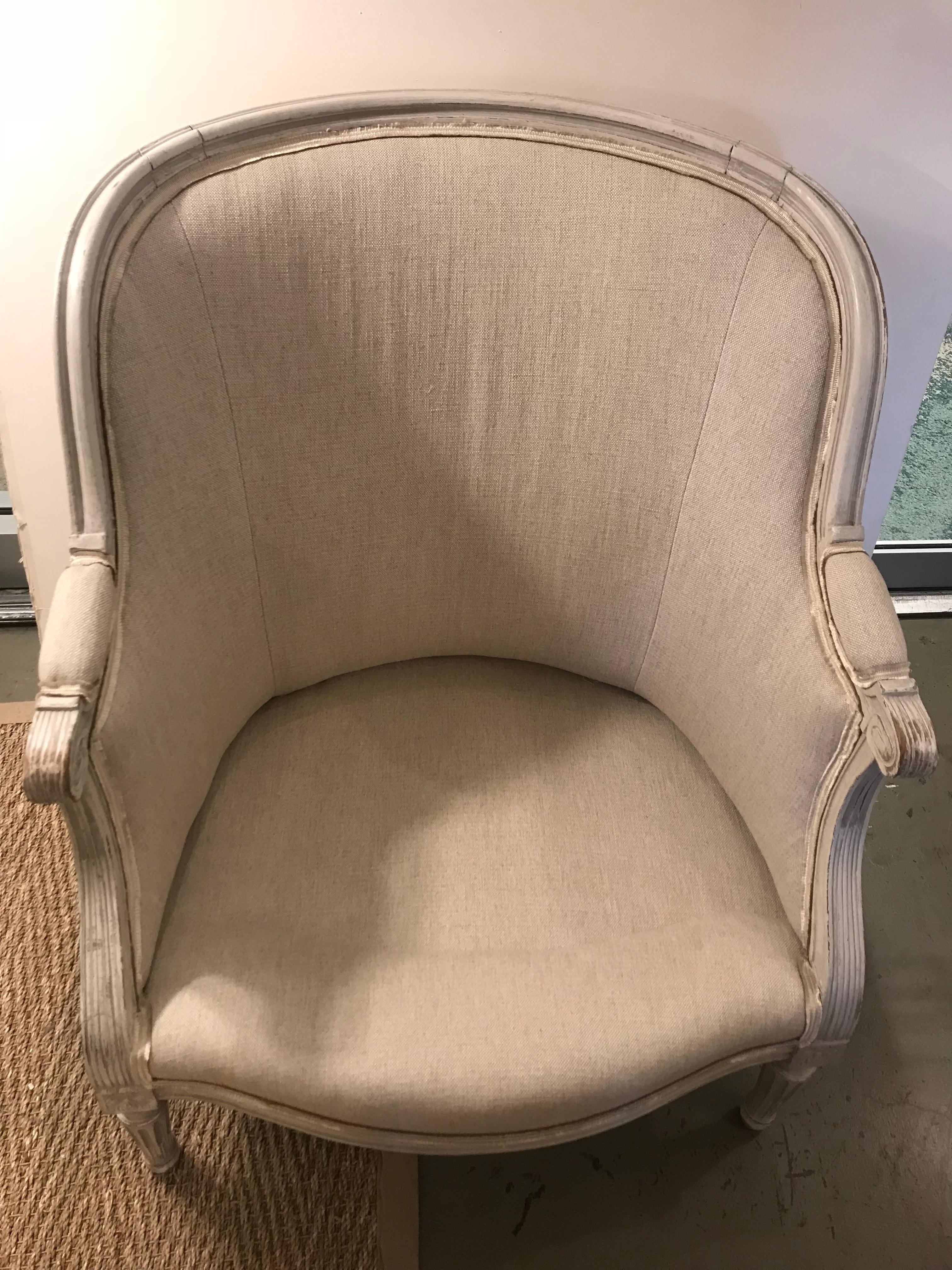 18th century Louis XVI period bergere frame. Newly reupholstered in neutral fabric with trimmings.