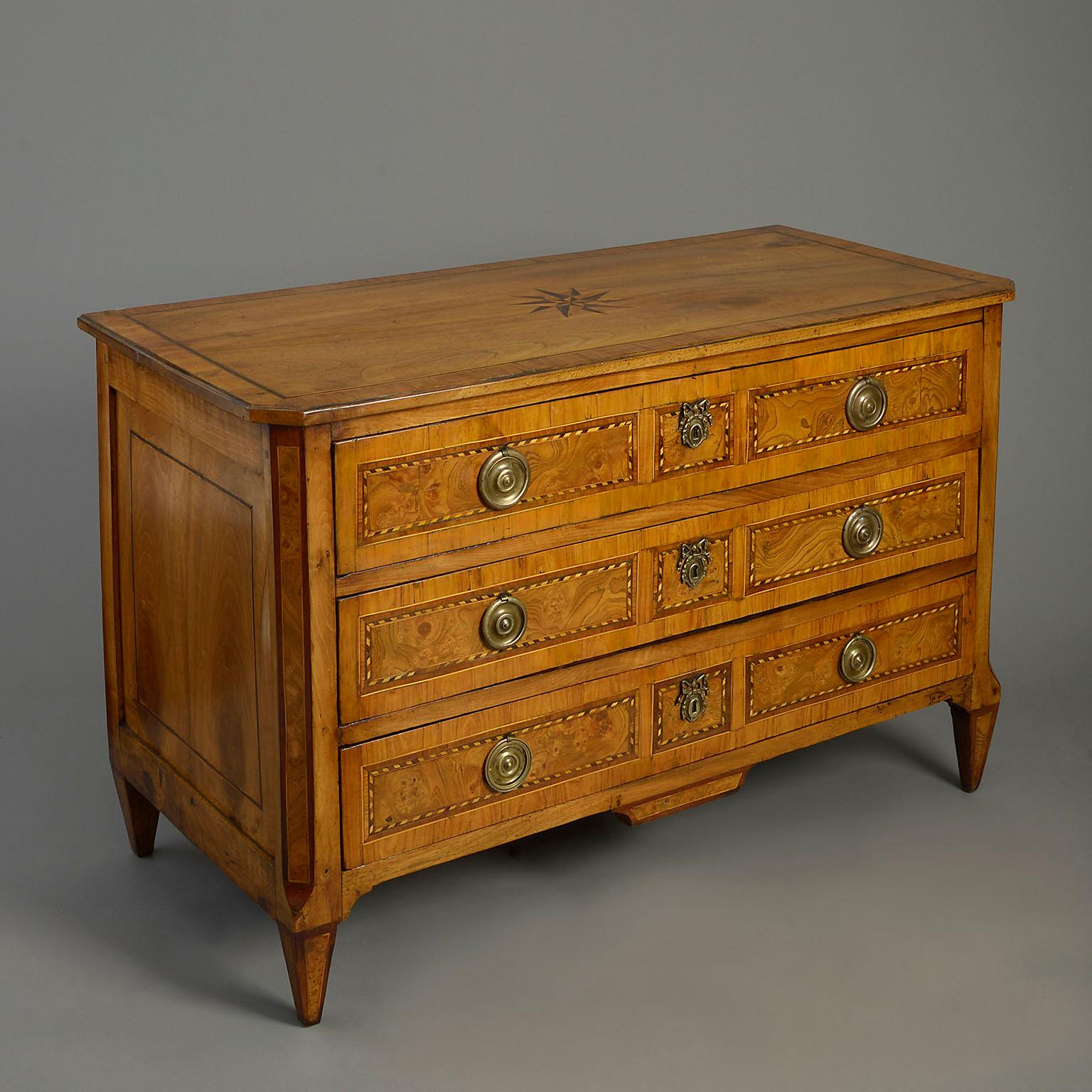 An 18 century Louis XVI Period walnut parquetry commode, the top inlaid with a star motif, the three drawers with burr elm veneered panelling, brass lock escutcheons and handles, all raised on square tapering feet.