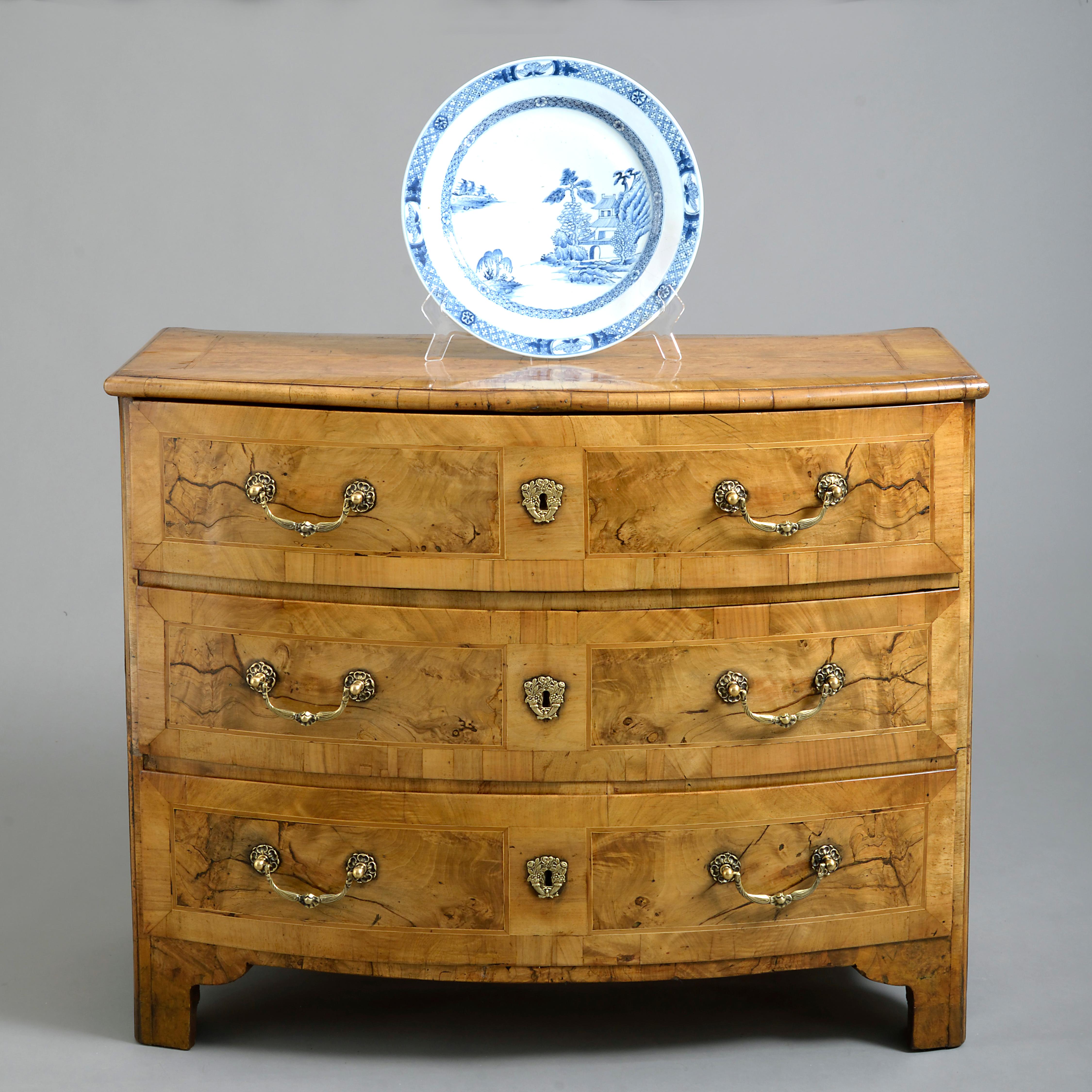 A late 18th century Louis XVI period finely figured burr walnut bow fronted commode, having three long drawers with finely chased brass handles and escutcheons, crossbanding throughout and raised on bracket feet.