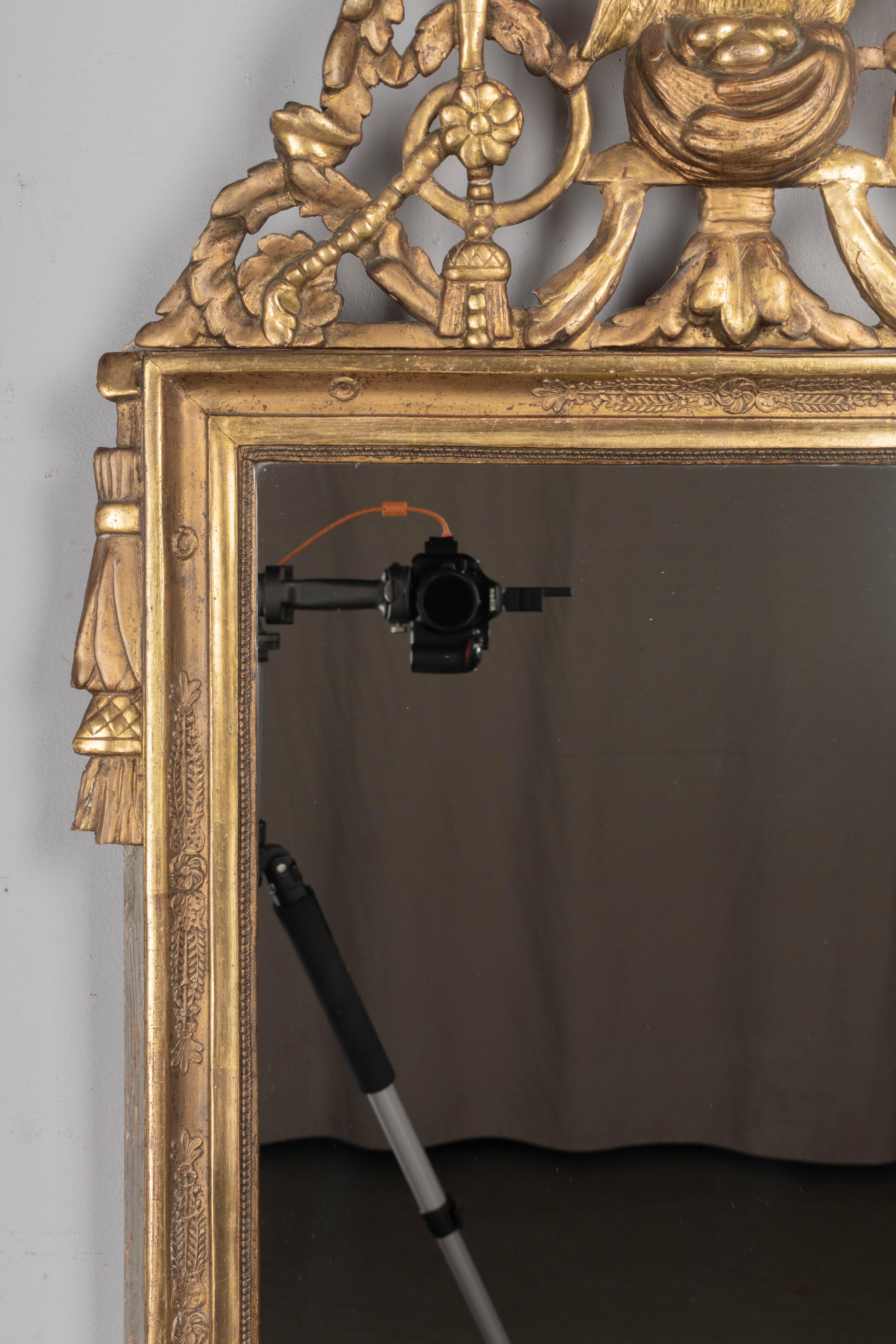 Hand-Carved 18th Century Louis XVI Style Parcel Gilt Mirror For Sale