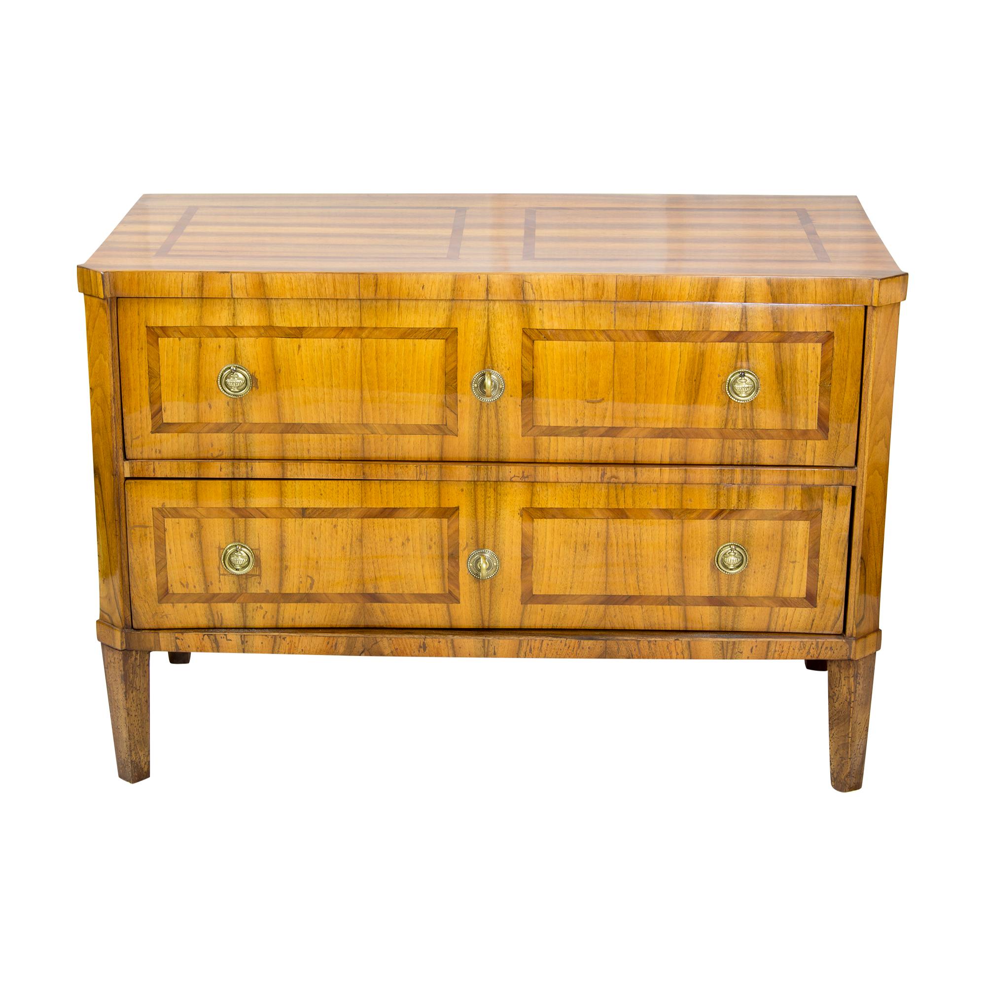 Chest of drawers with two drawers on pointed feet. Beautiful walnut veneer with ribbon inlays on pine body. The furniture has a very clear beautiful design without much ornamentation and comes from the Empire period and has with its gradliniegkeit