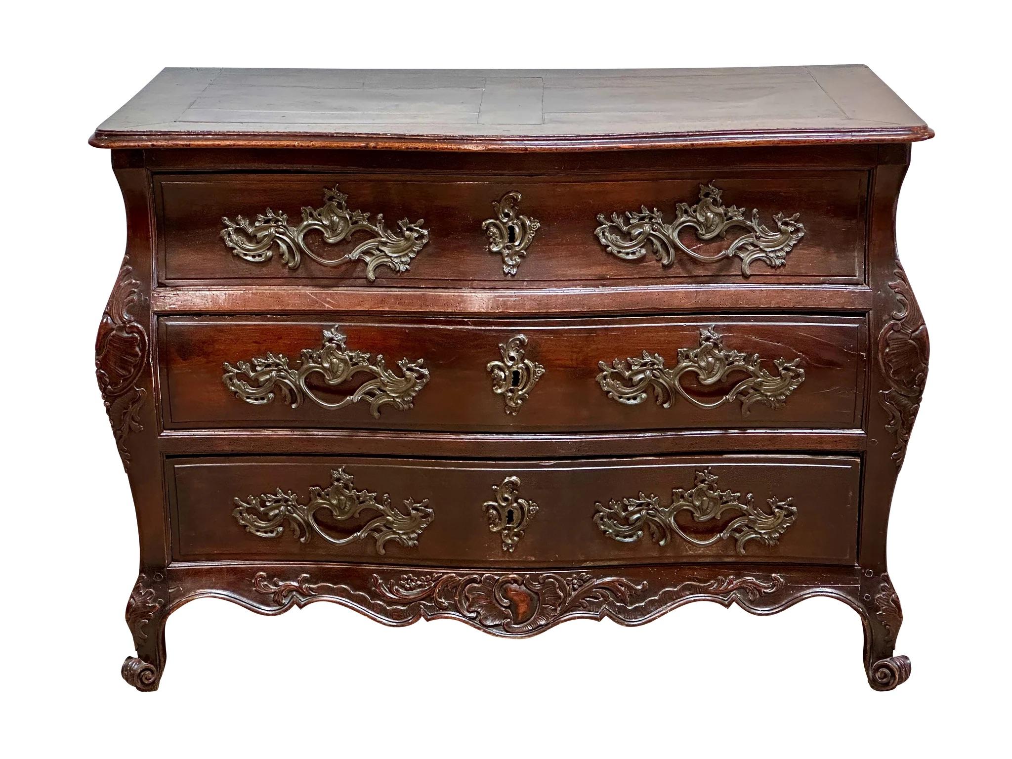18th Century Louise XV French richly hued Walnut Bombe Commode Serpentine top and front, bombe form case, three drawers with applied bronze and escutcheons,. Carved and shaped foliate scroll skirt, scroll feet. 
