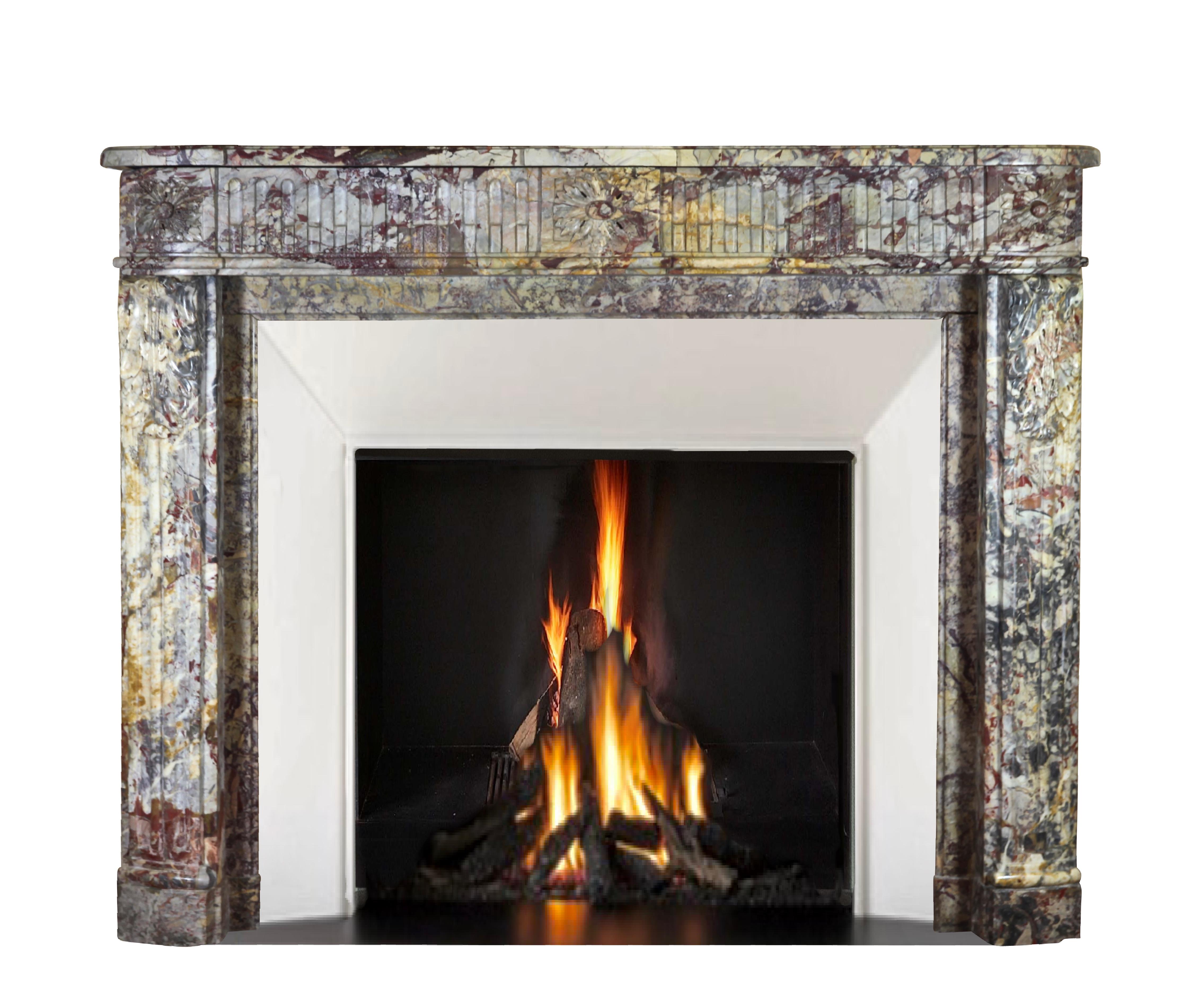 This original 18th century Royal French Saracolin marble fireplace surround is from the Louis XVI period. It has rounded corners and an exceptionally rich and brilliant color combination. The mantel is in perfect condition. It is stunning and