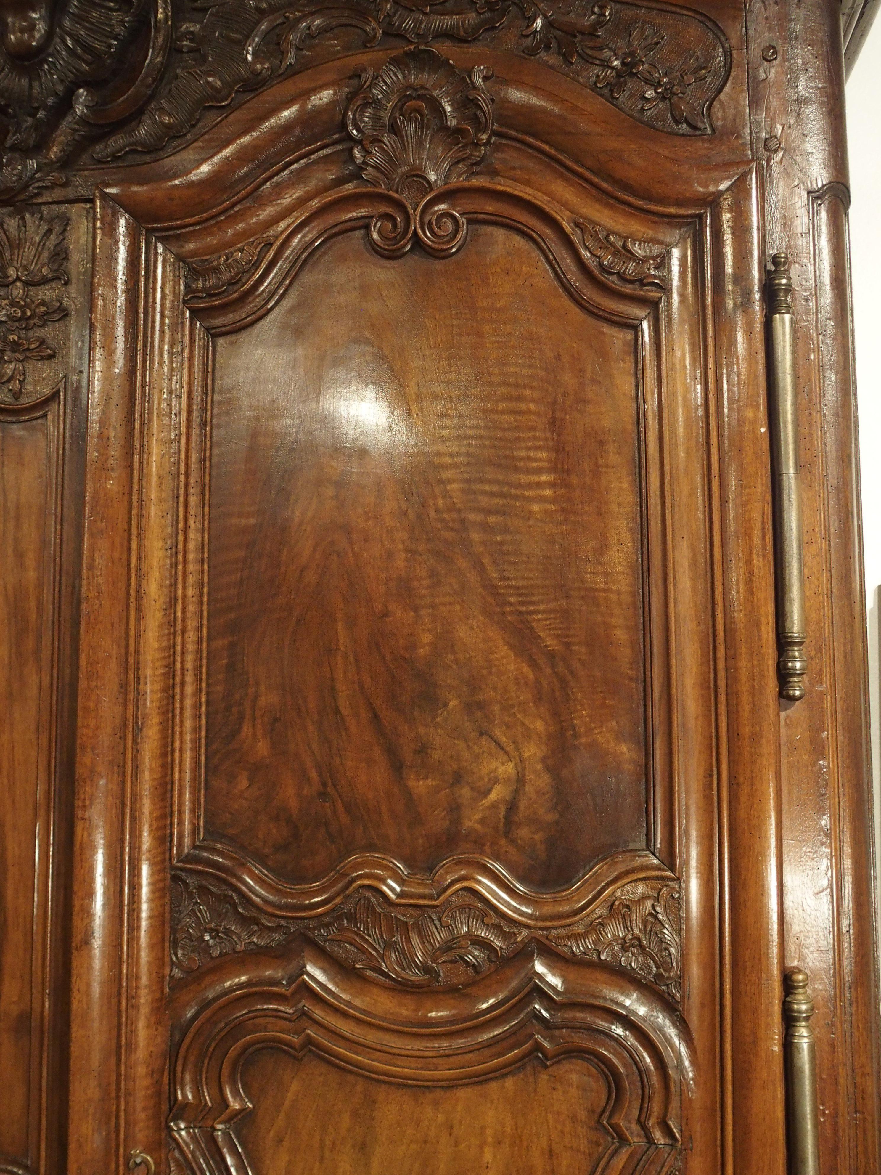 This fantastic walnut wood armoire was hand-carved in Lyon (southeast France) in the 1700’s. 18th century armoires from Lyon are quite distinct, thanks to techniques used by ebenistes to make their furniture standout from other woodworkers