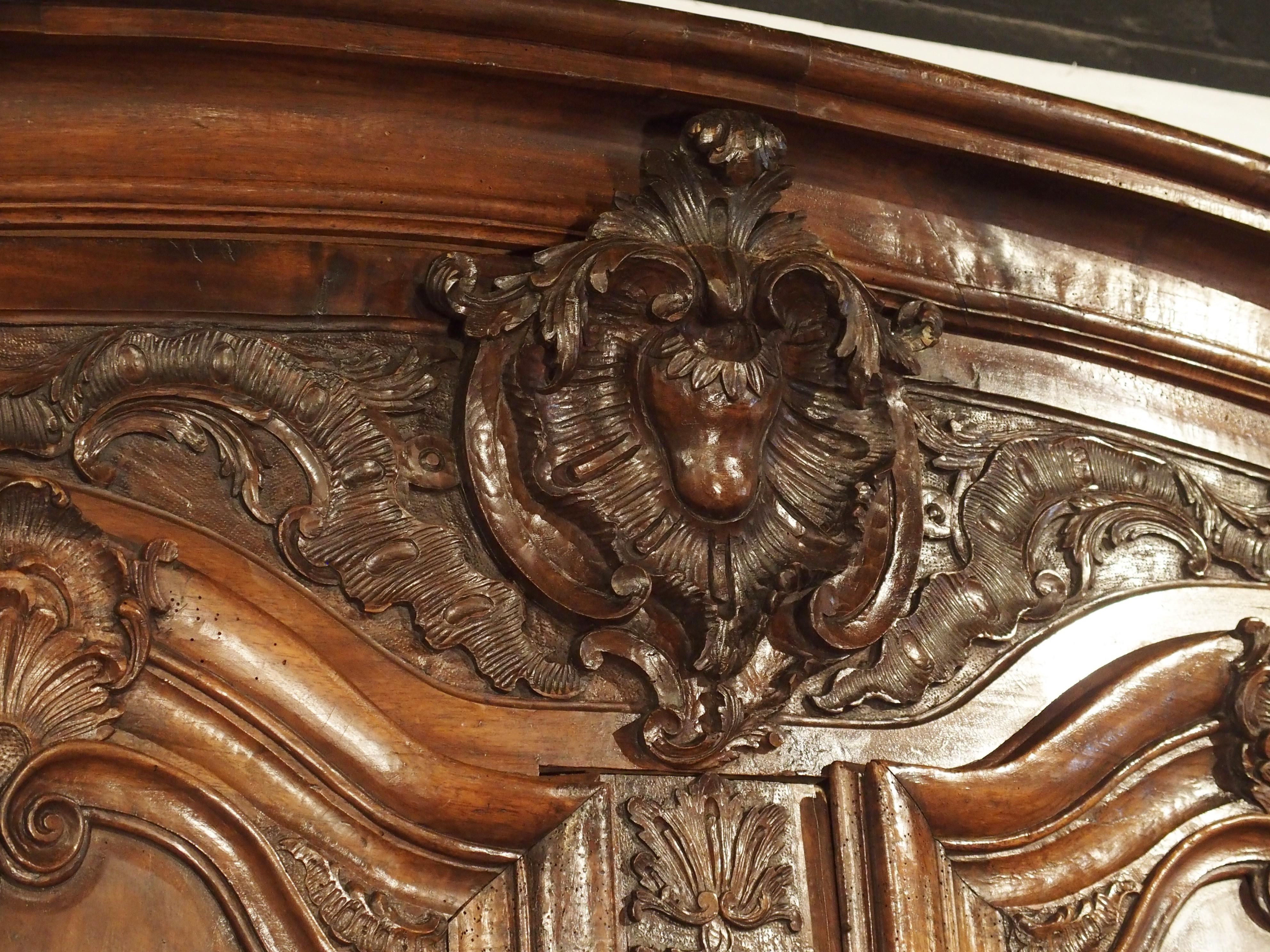 Iron 18th Century Lyonnaise Armoire in Carved Walnut Wood