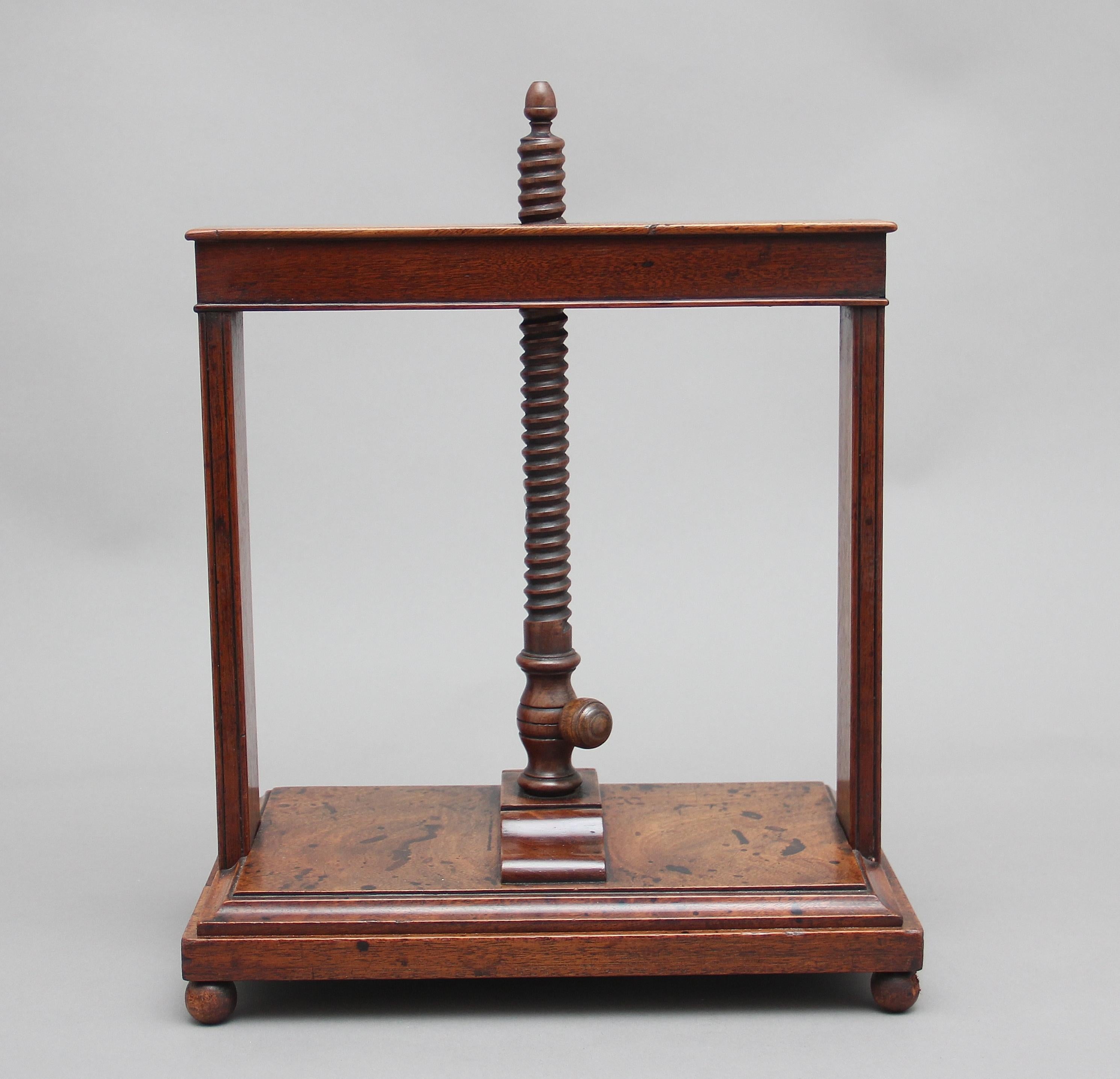 18th century mahogany book press, having a spiral thread mechanism, lovely quality moulded press, supported on turned feet, in good working order, circa 1790.

         