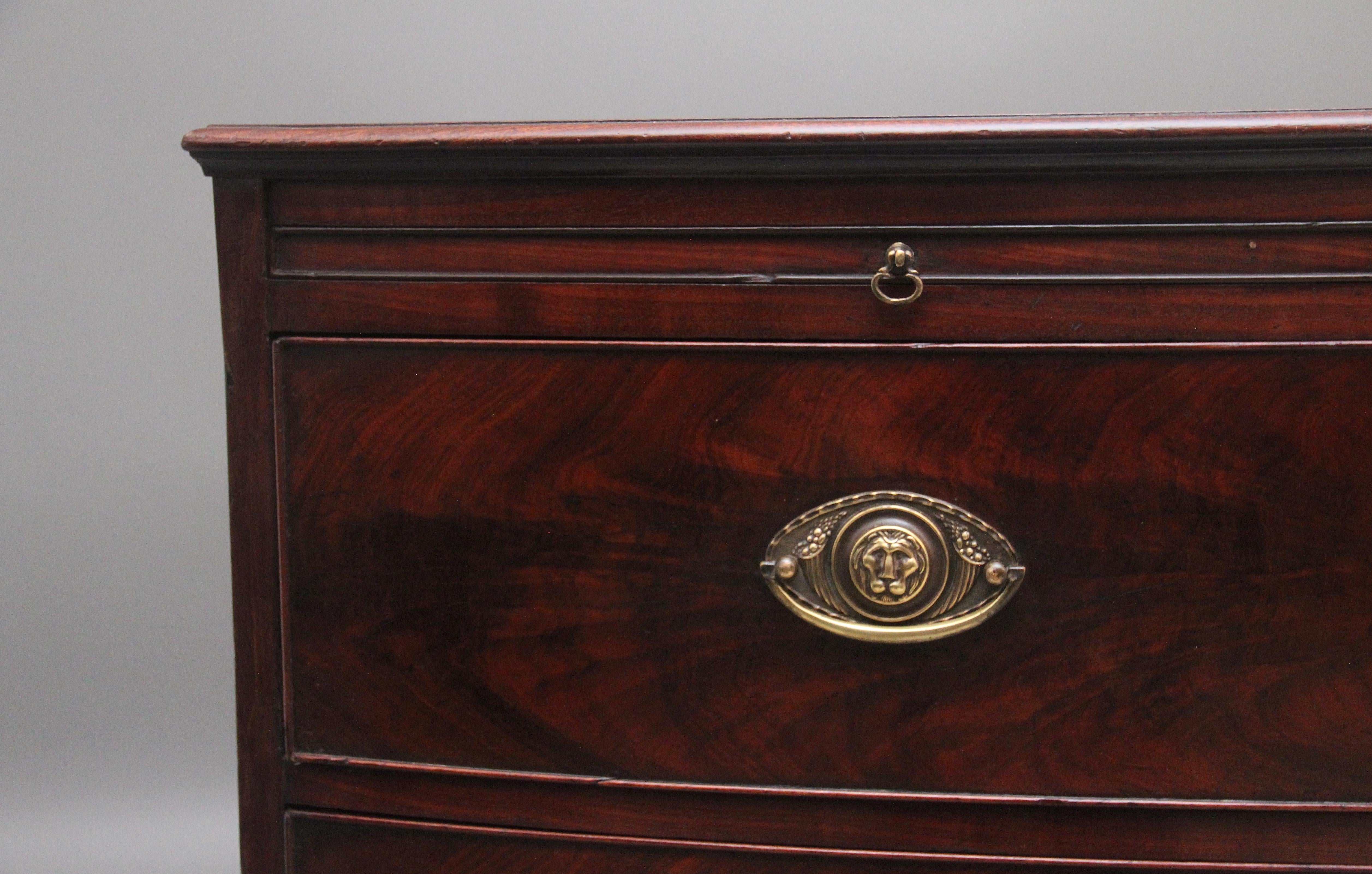 18th Century mahogany bowfront chest of drawers, having a nice figured top with a moulded edge above a brushing slide, three graduated oak lined drawers below with lovely flame mahogany drawer fronts with oval brass plate handles, shaped apron on