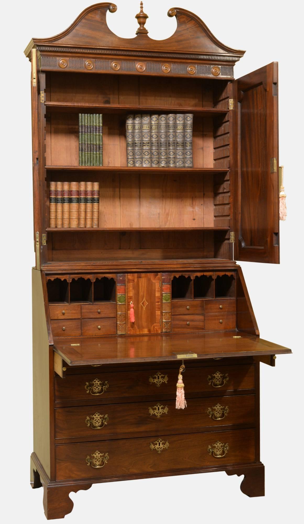 Mahogany bureau bookcase. Oak drawer linings, secret drawers, swan pediment with finial. Has roundels and finely executed dentil moulding, Kingwood crossbanding to interior cupboard door. Replacement handles,

circa 1760.