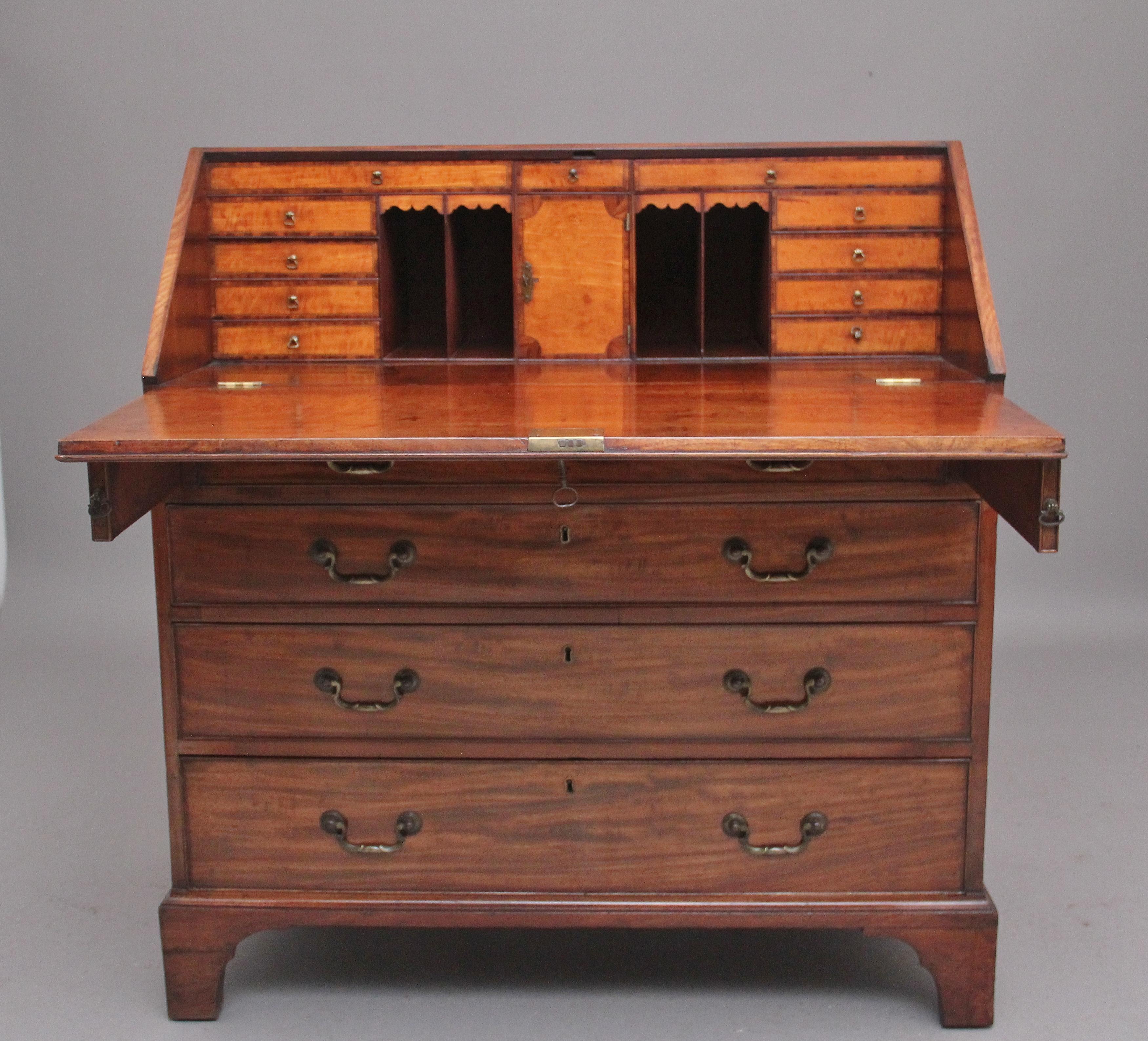 A superb quality 18th Century mahogany Georgian bureau, the hinged fall lifting down to reveal a lovely fitted interior consisting of eleven oak lined drawers, various compartments and central cupboard with a hinged door, the drawer and door fronts